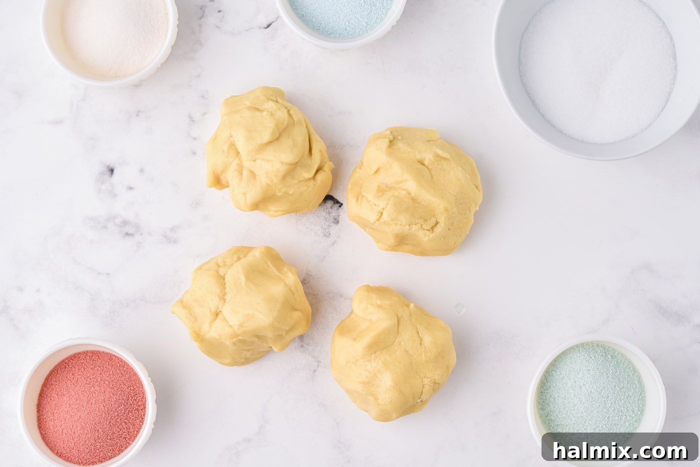sugar cookie dough divided into four equal balls