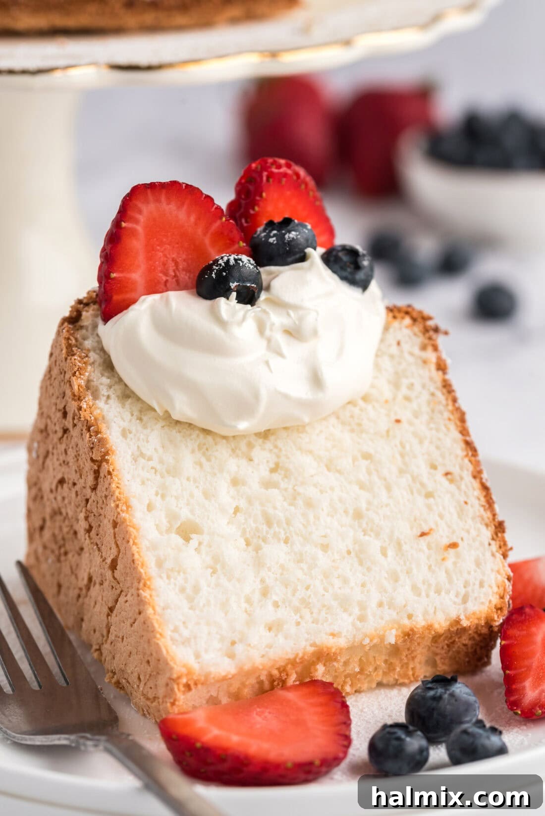 Feather-Light Angel Food Cake 2 Slice of homemade Angel Food Cake topped with fresh whipped cream and vibrant berries
