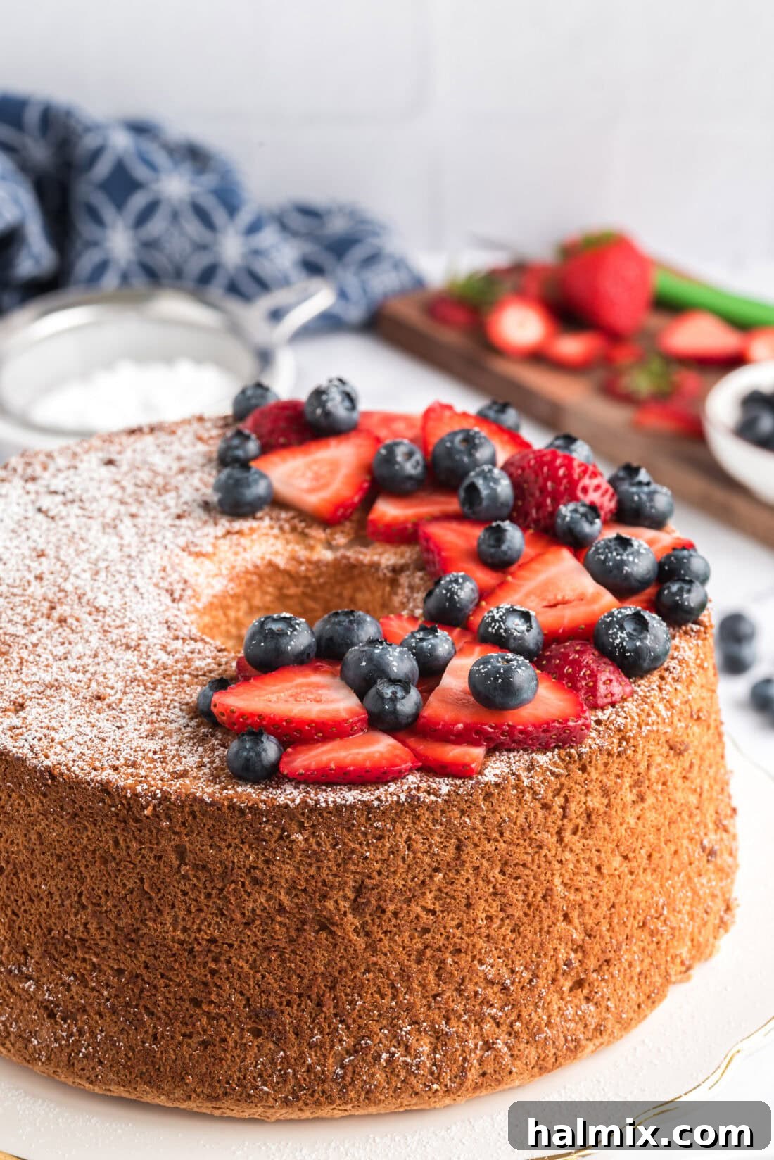 Feather-Light Angel Food Cake 14 A beautifully decorated Angel Food Cake topped with a generous dusting of powdered sugar and fresh red berries