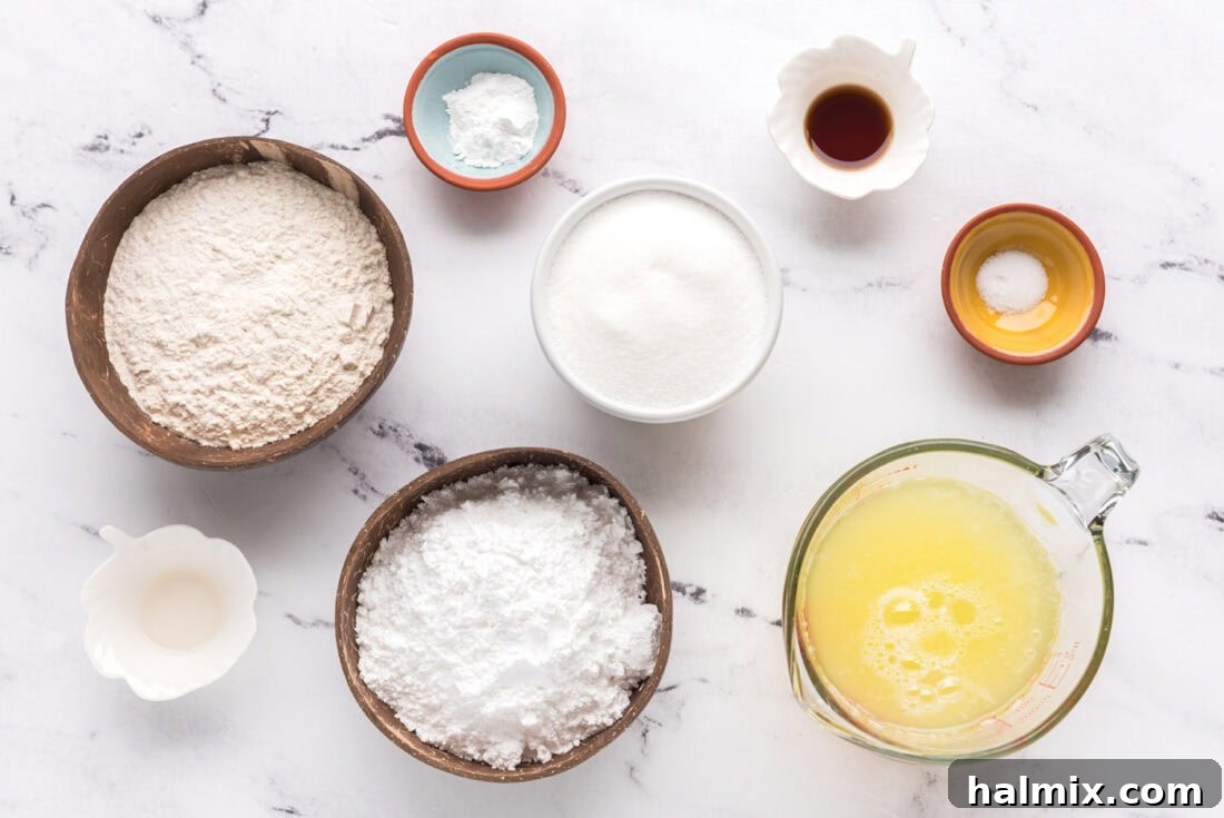 Feather-Light Angel Food Cake 4 All ingredients laid out on a table for making homemade Angel Food Cake: egg whites, flours, sugars, extracts, cream of tartar, and salt
