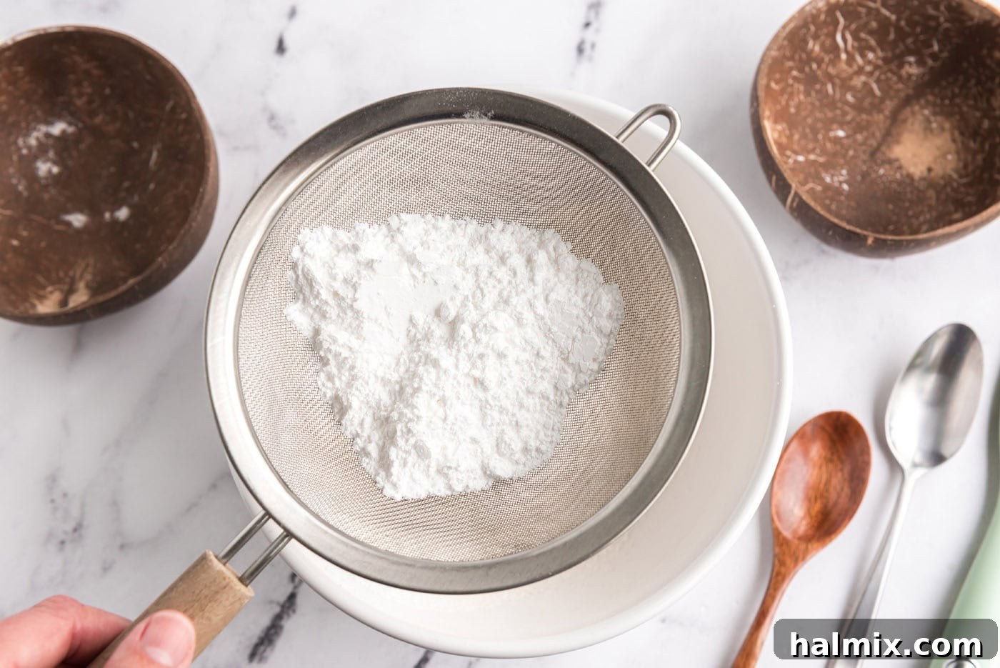 Feather-Light Angel Food Cake 6 Sifting powdered sugar and flour into a bowl multiple times for angel food cake batter