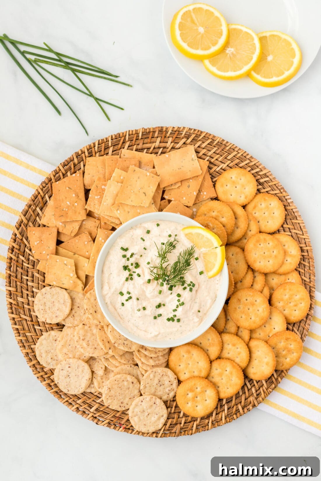Smoked Salmon Dip in a bowl surrounded by crackers, a perfect party appetizer.