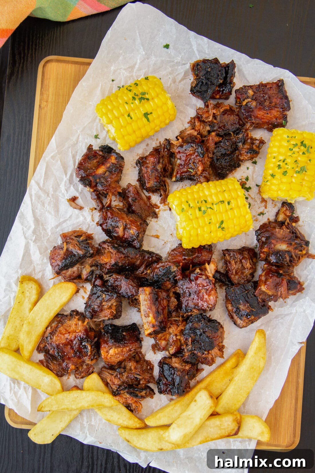 Smoked Rib Nuggets 2 Rib Tips with fries and corn on cutting board, ready to be enjoyed.