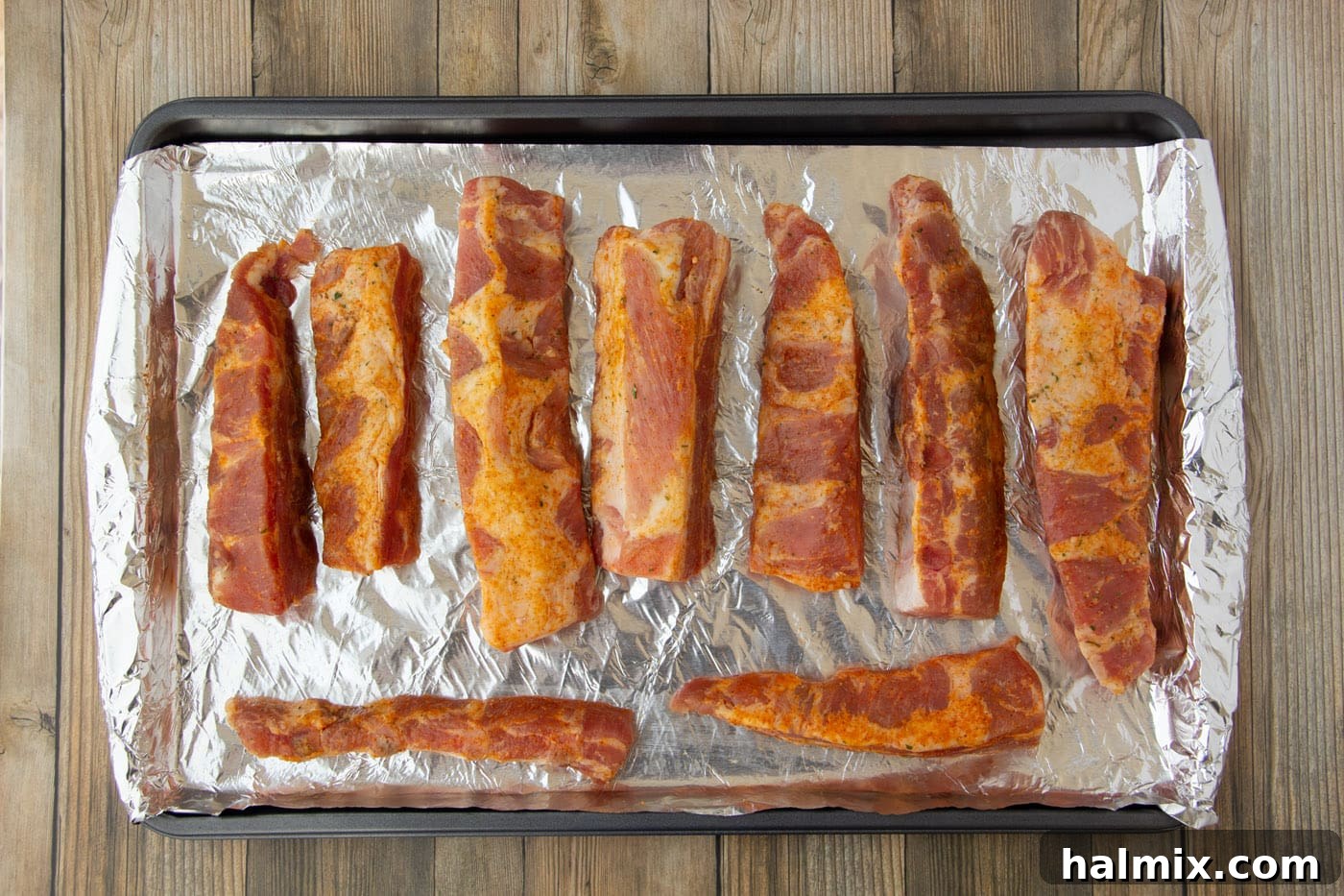Smoked Rib Nuggets 5 rib tips on a baking sheet, covered with foil.