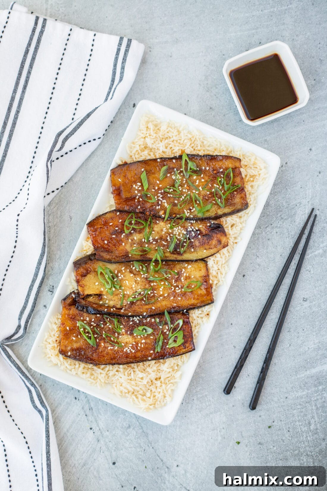 Soy Glazed Eggplant over rice on a platter