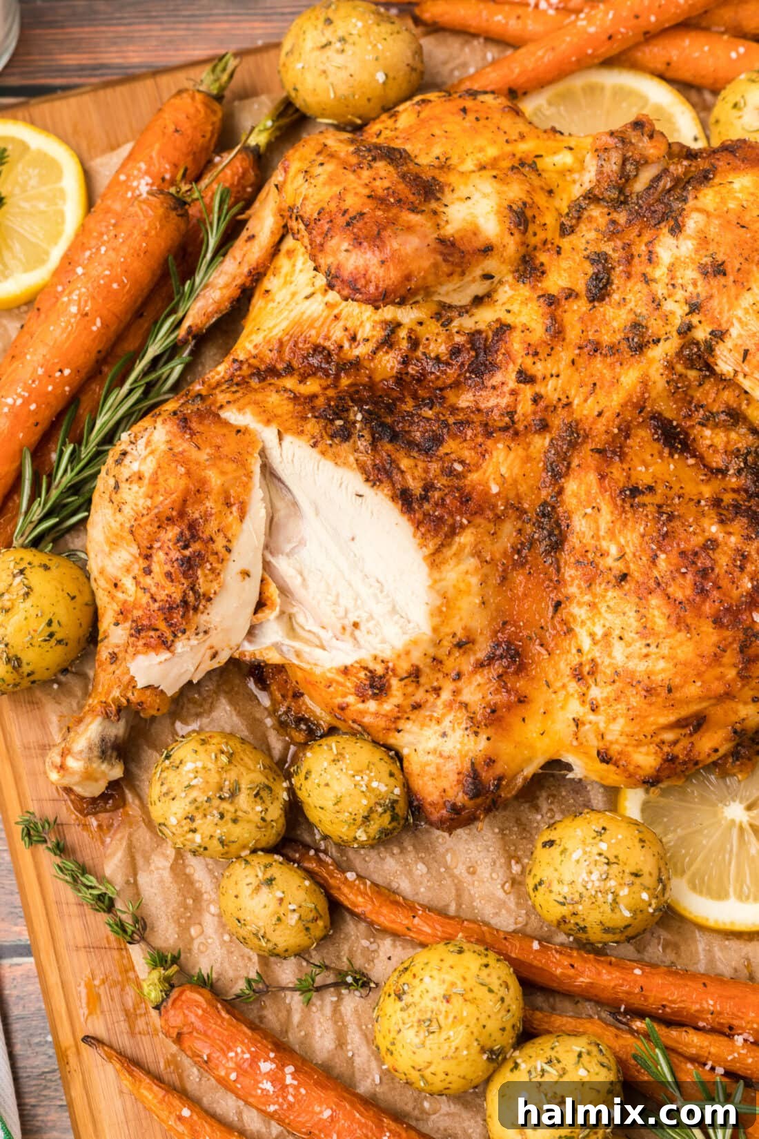 Close up of a perfect slice from a Spatchcock Chicken showing crispy skin and juicy meat