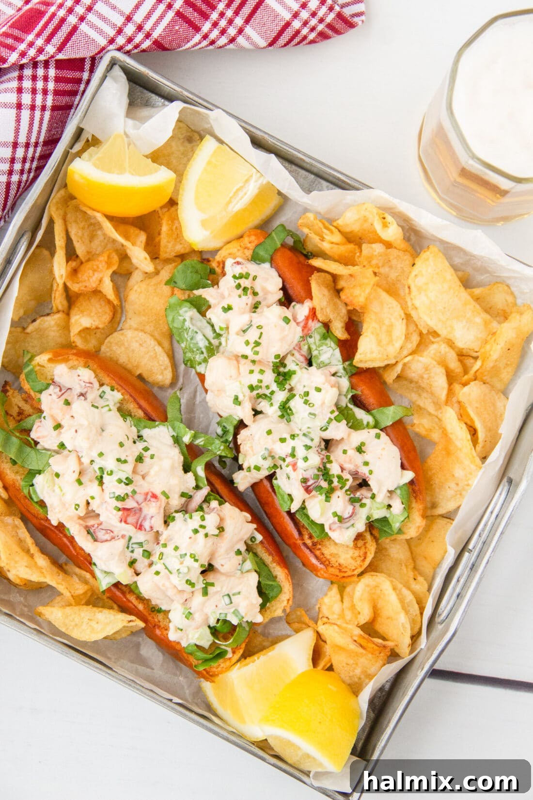 Classic Lobster Roll with golden potato chips, showcasing succulent lobster meat in a toasted bun