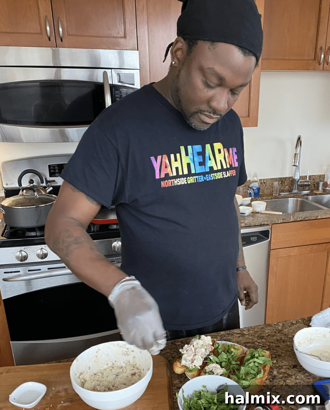 Chef Antoine meticulously mixing ingredients for the lobster roll dressing in a bowl