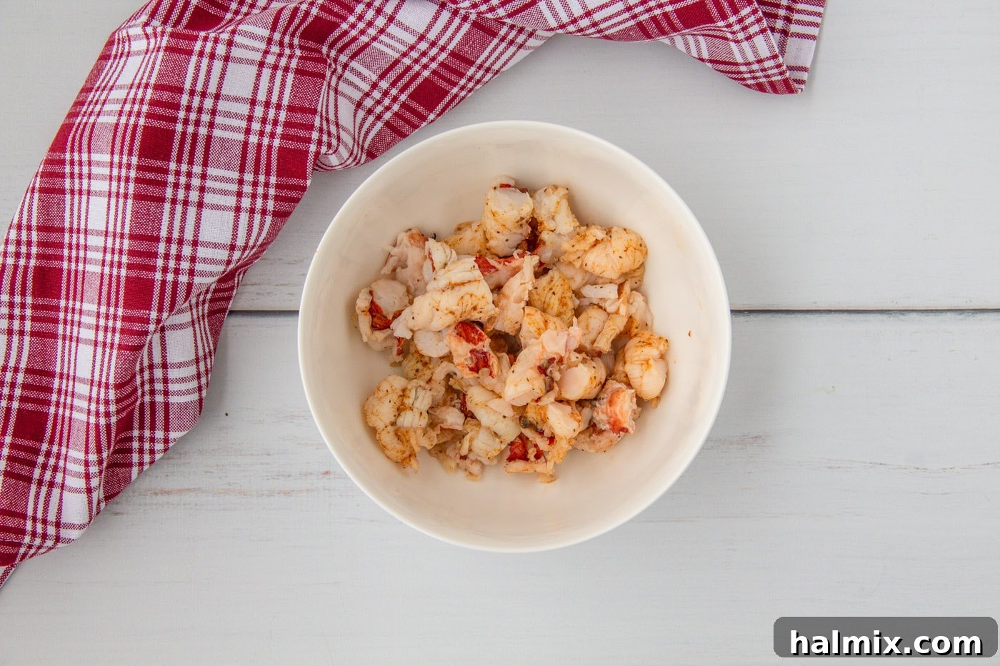 Chopped lobster tail meat neatly arranged in a bowl, ready for the dressing
