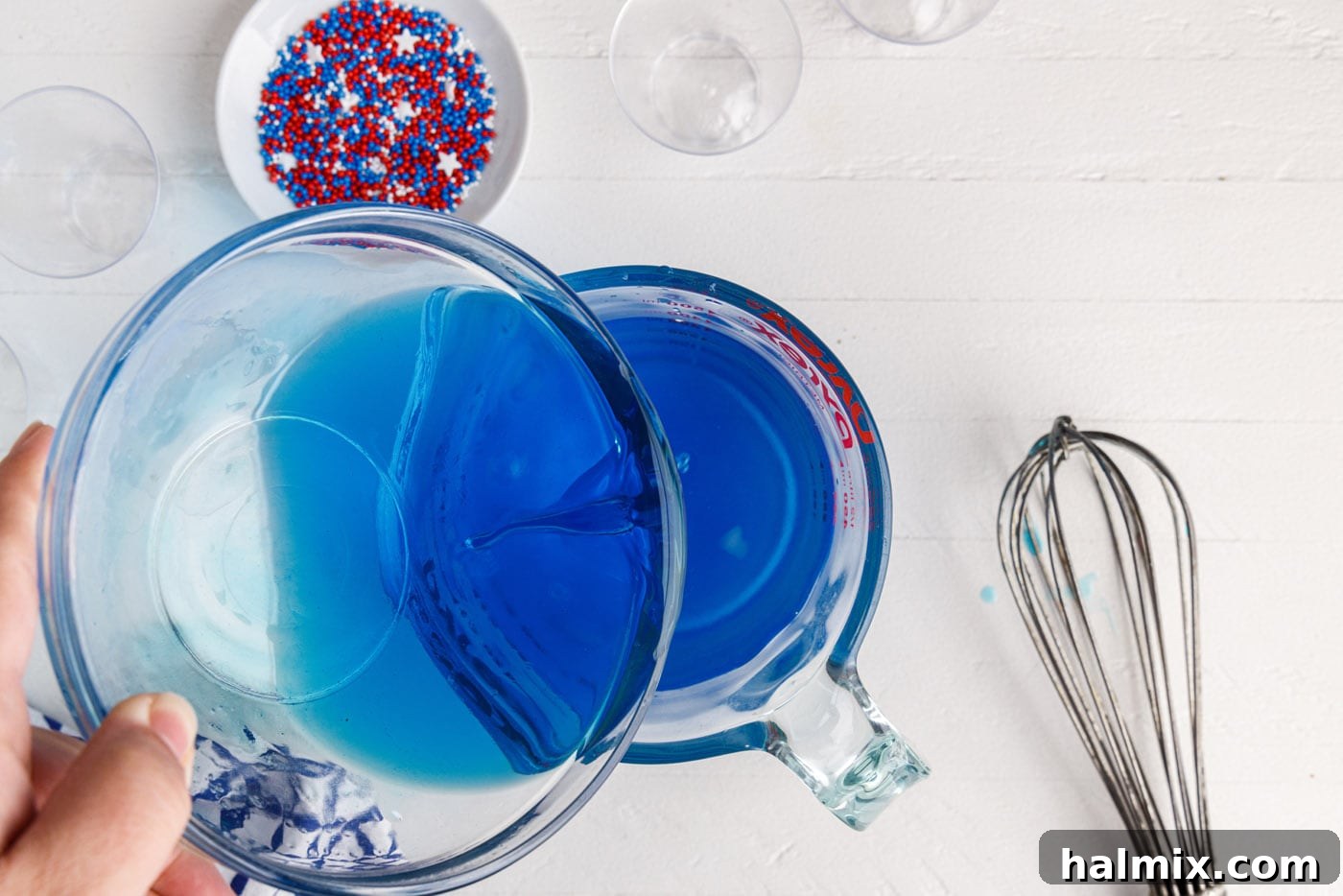 pouring alcohol into blue jello