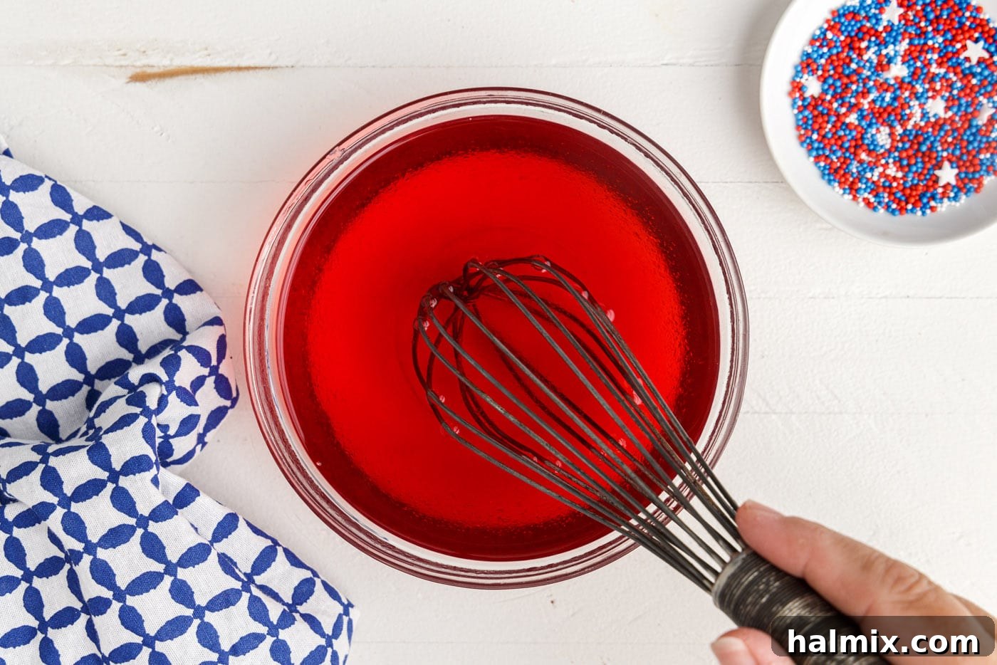 whisking red jello with water