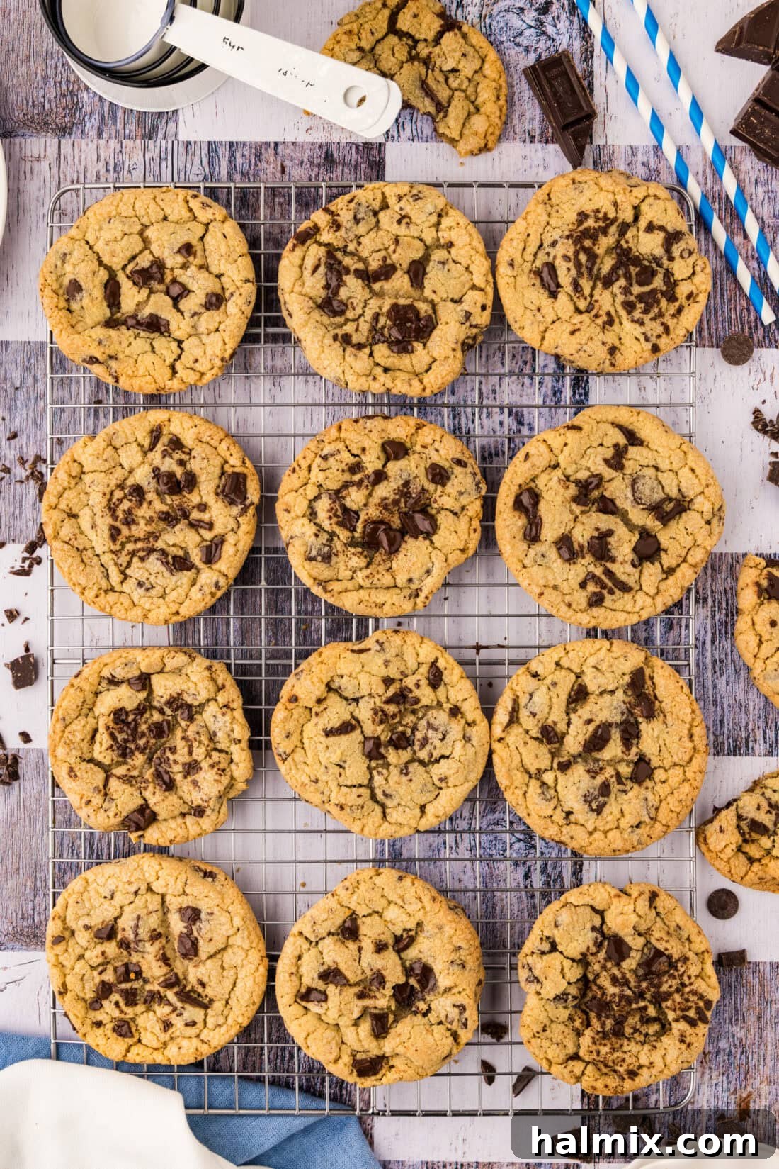 Freshly baked jumbo chocolate chip cookies cooling on a wire rack