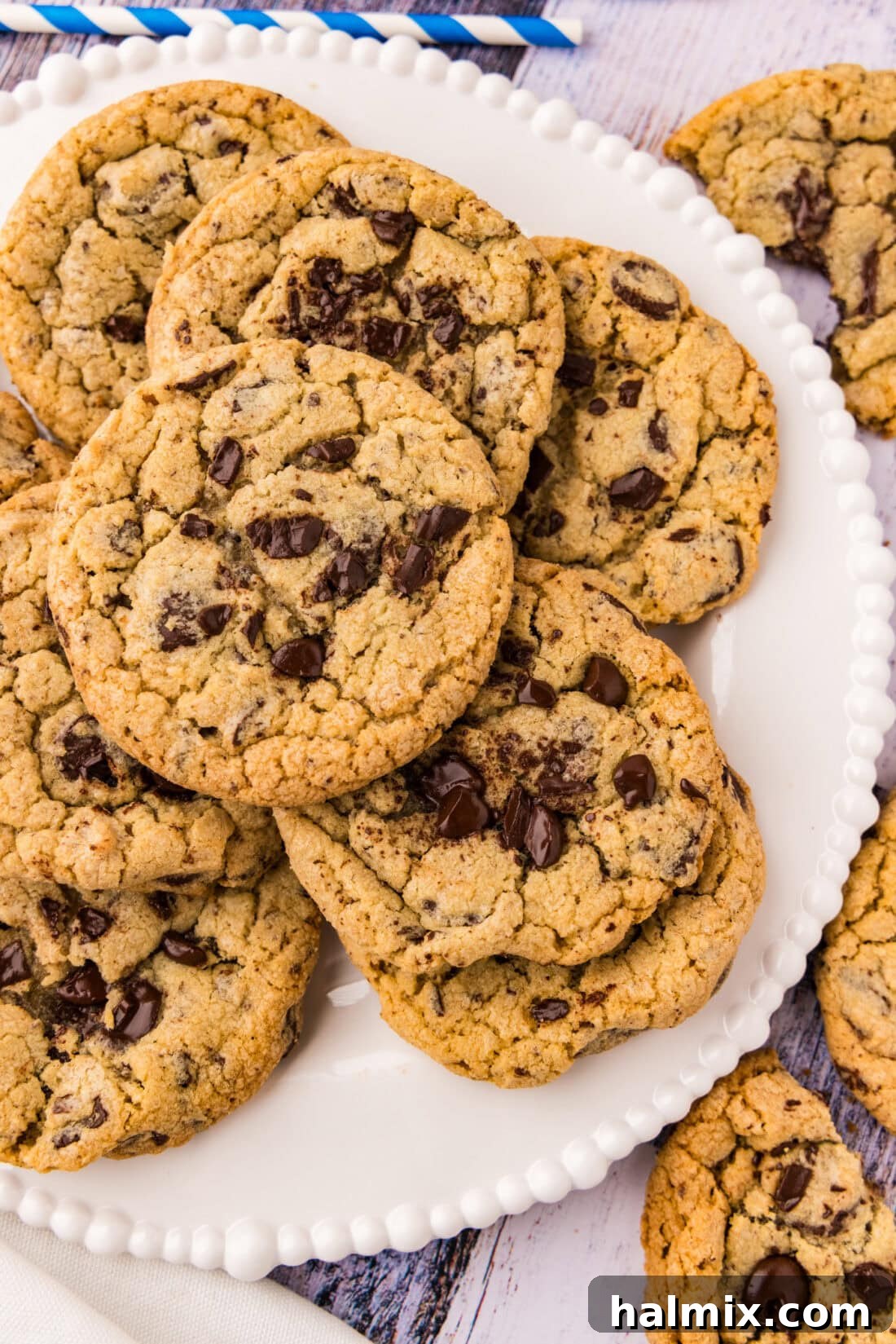 Close up photo of perfectly baked jumbo chocolate chip cookies on a plate