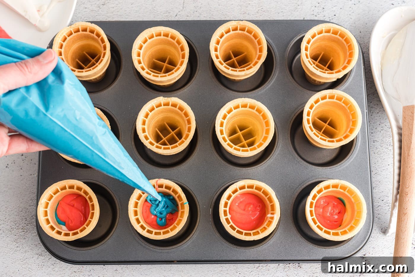 Stars and Stripes Cone Cakes 8 Piping blue cake batter into an ice cream cone for patriotic cupcakes