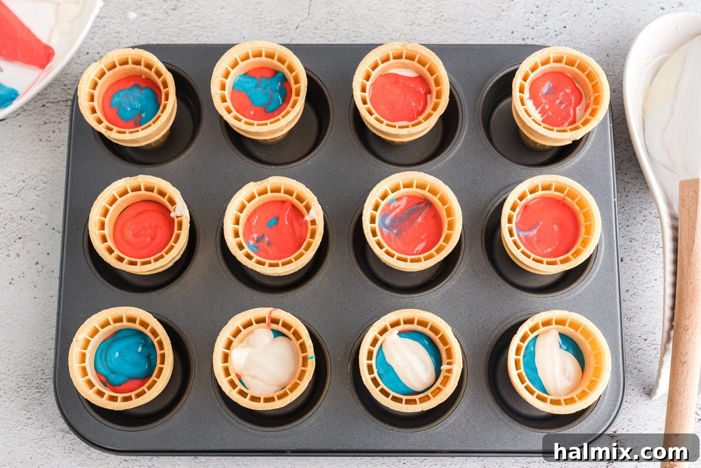 Stars and Stripes Cone Cakes 9 Patriotic ice cream cone cupcakes filled with batter and ready for baking in a cupcake pan