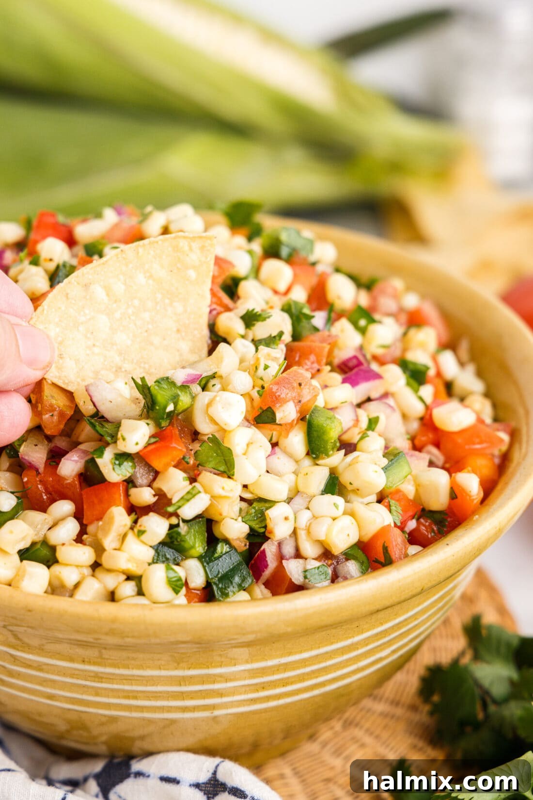dipping chip in Corn Salsa