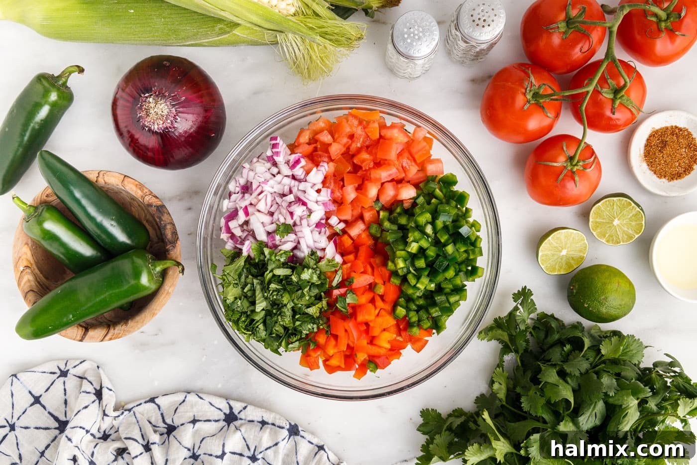 corn, tomatoes, onion, cilantro, and bell peppers in a bowl
