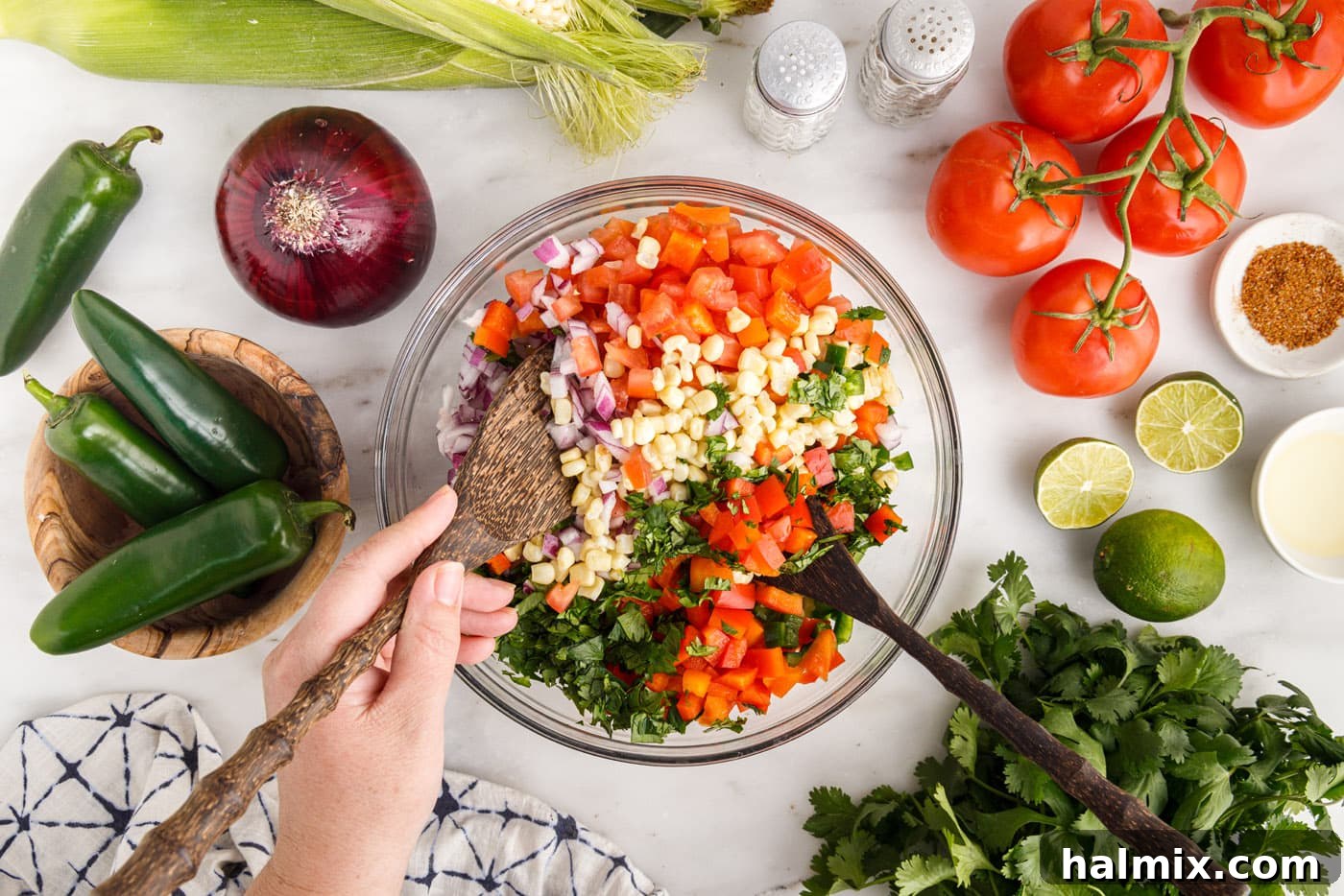 mixing corn salsa in a bowl