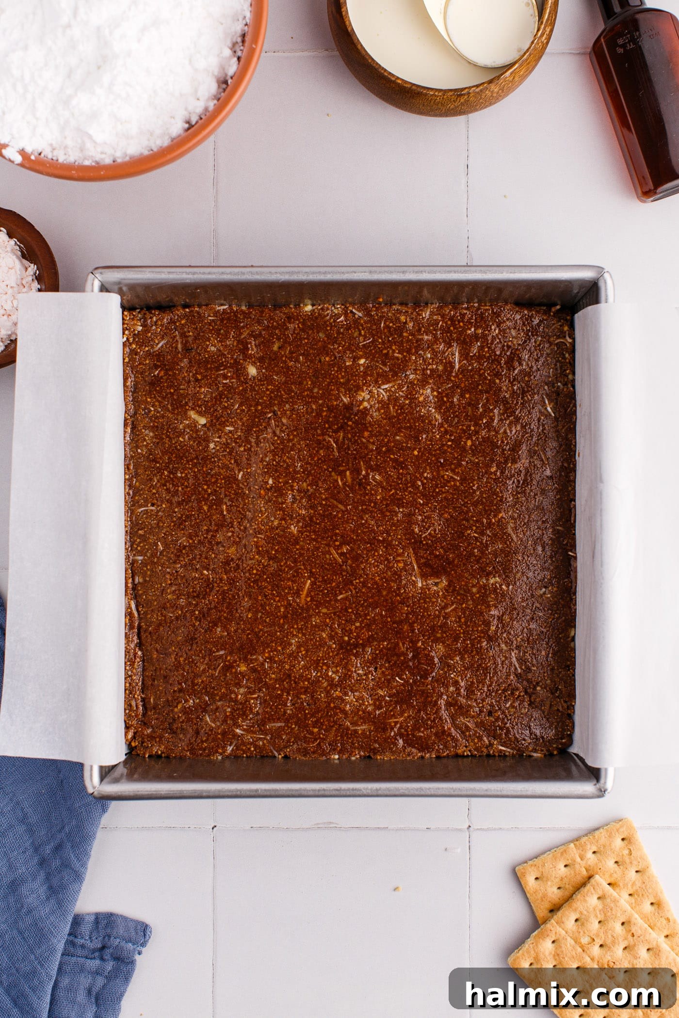 The Nanaimo bar crust pressed into a baking pan.