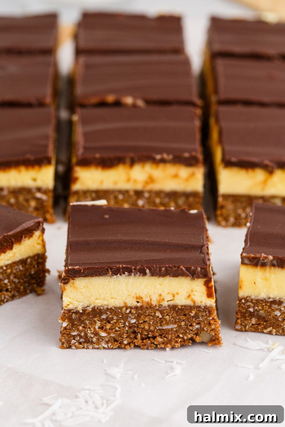 Perfectly cut Nanaimo Bars arranged on a platter.