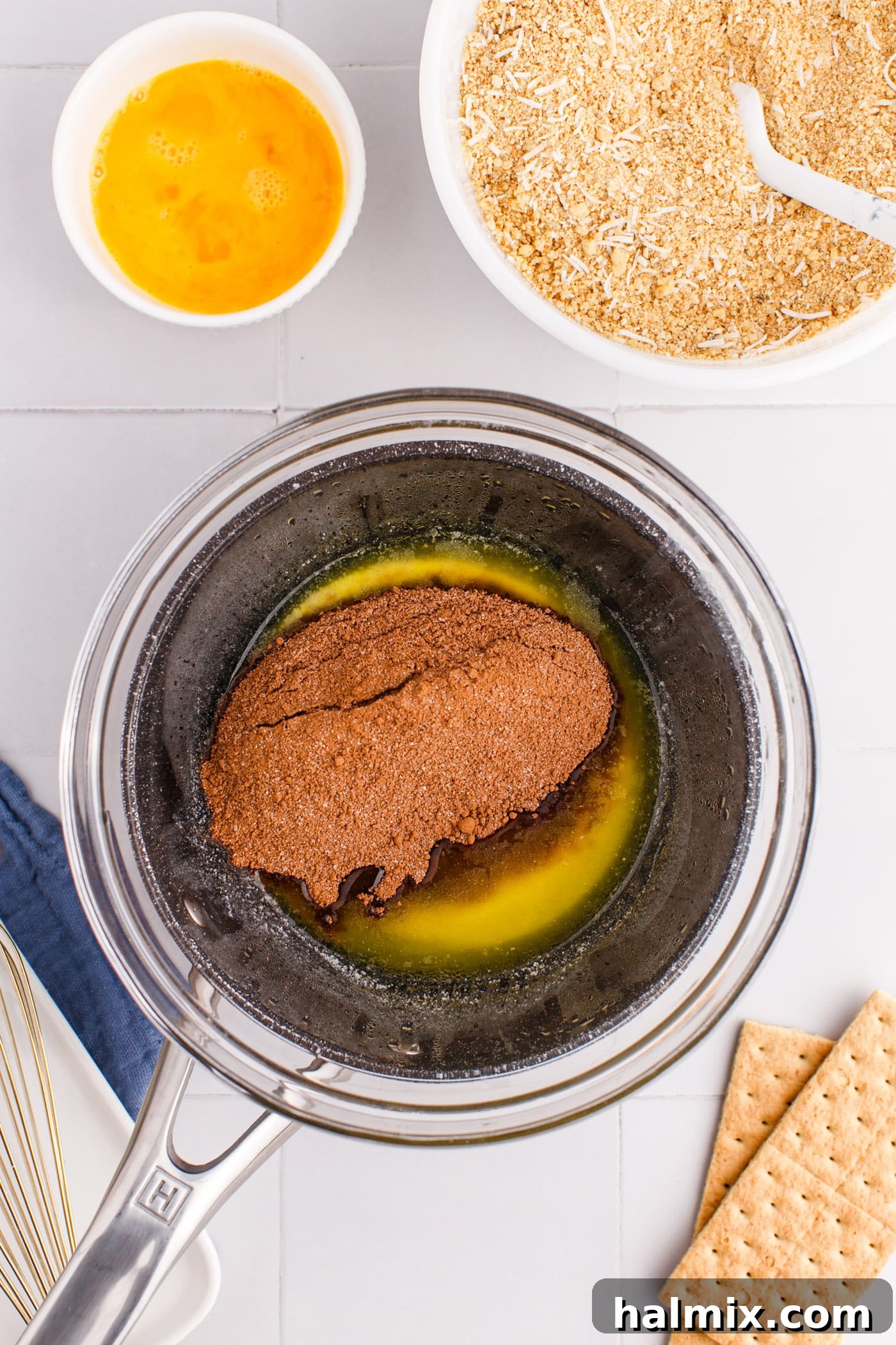 Melted butter is combined with cocoa powder and sugar on the stovetop.