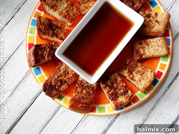 Prepping French Toast for Freezing A baking sheet filled with freshly made French toast slices cooling on a wire rack before being cut into sticks and frozen.