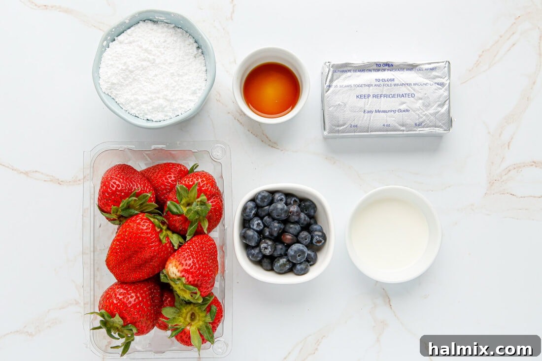 A collection of ingredients for making Cheesecake Stuffed Strawberries including fresh strawberries, cream cheese, powdered sugar, heavy cream, vanilla extract, and blueberries.