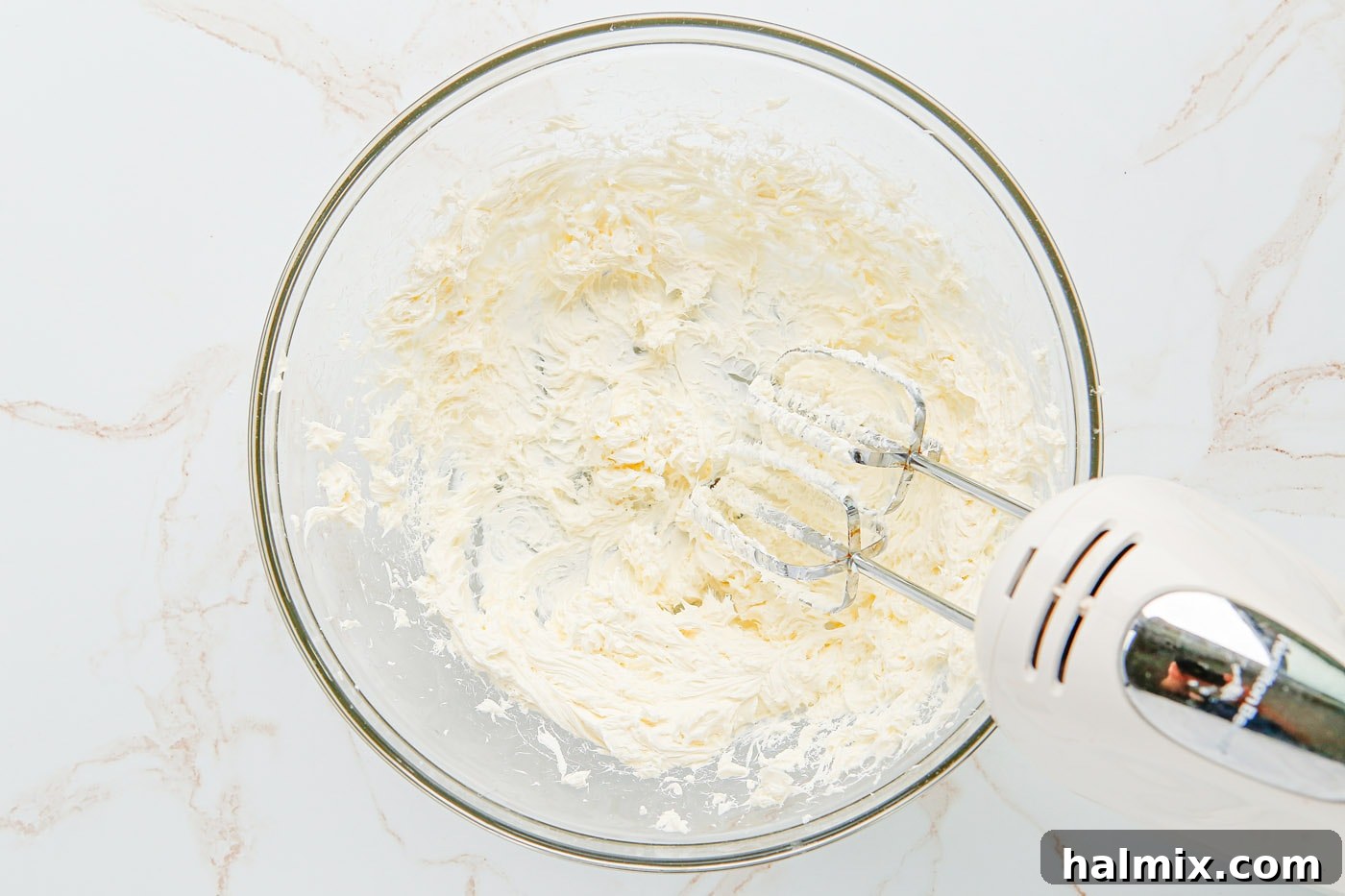The perfectly blended and creamy cheesecake mixture in a bowl, ready for piping.