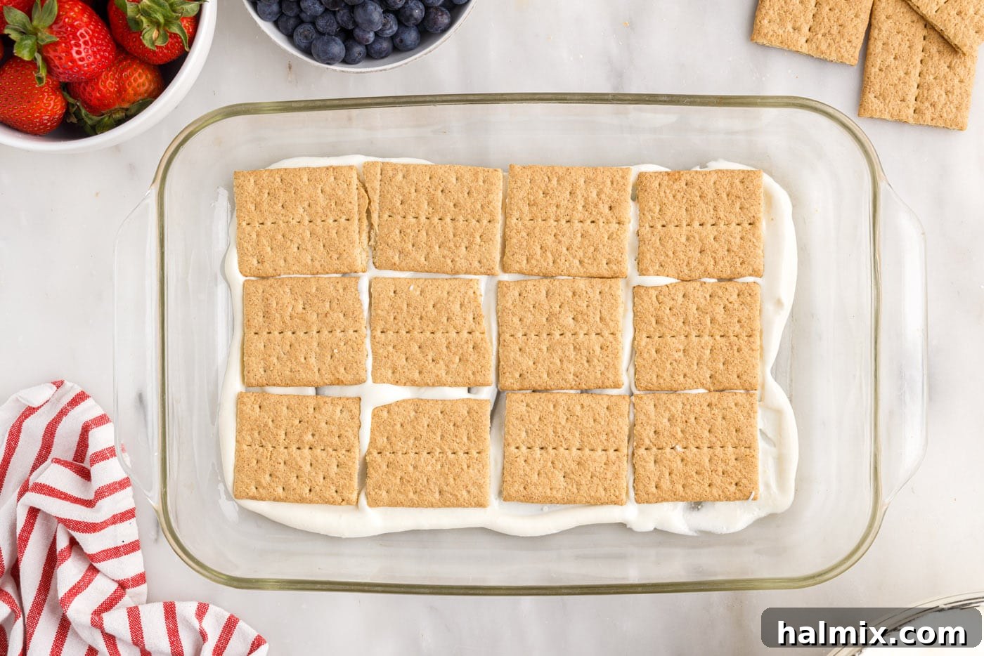 A single layer of graham crackers placed on top of the cool whip pudding mixture.