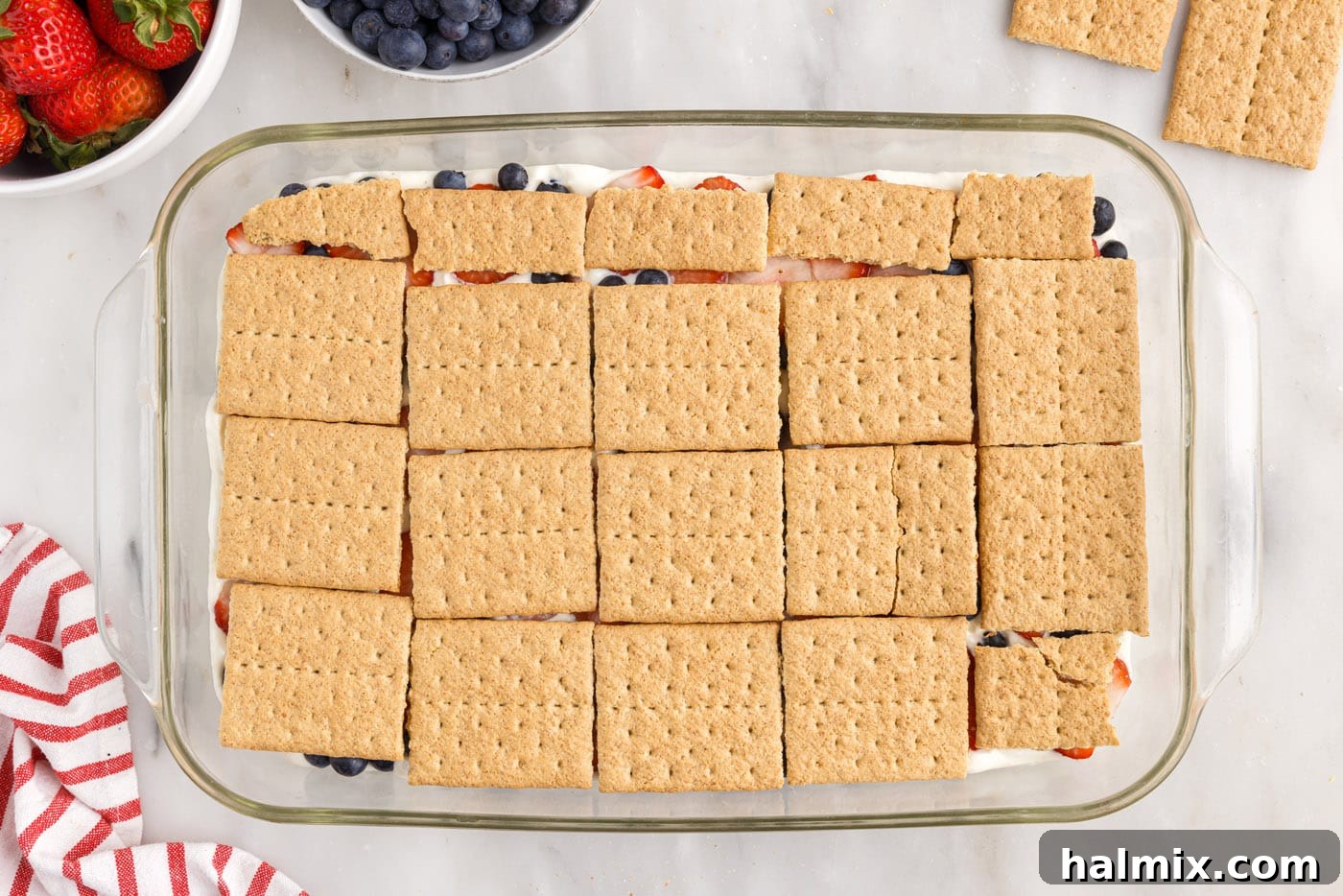 Another layer of graham crackers carefully placed over the berries and pudding mixture.