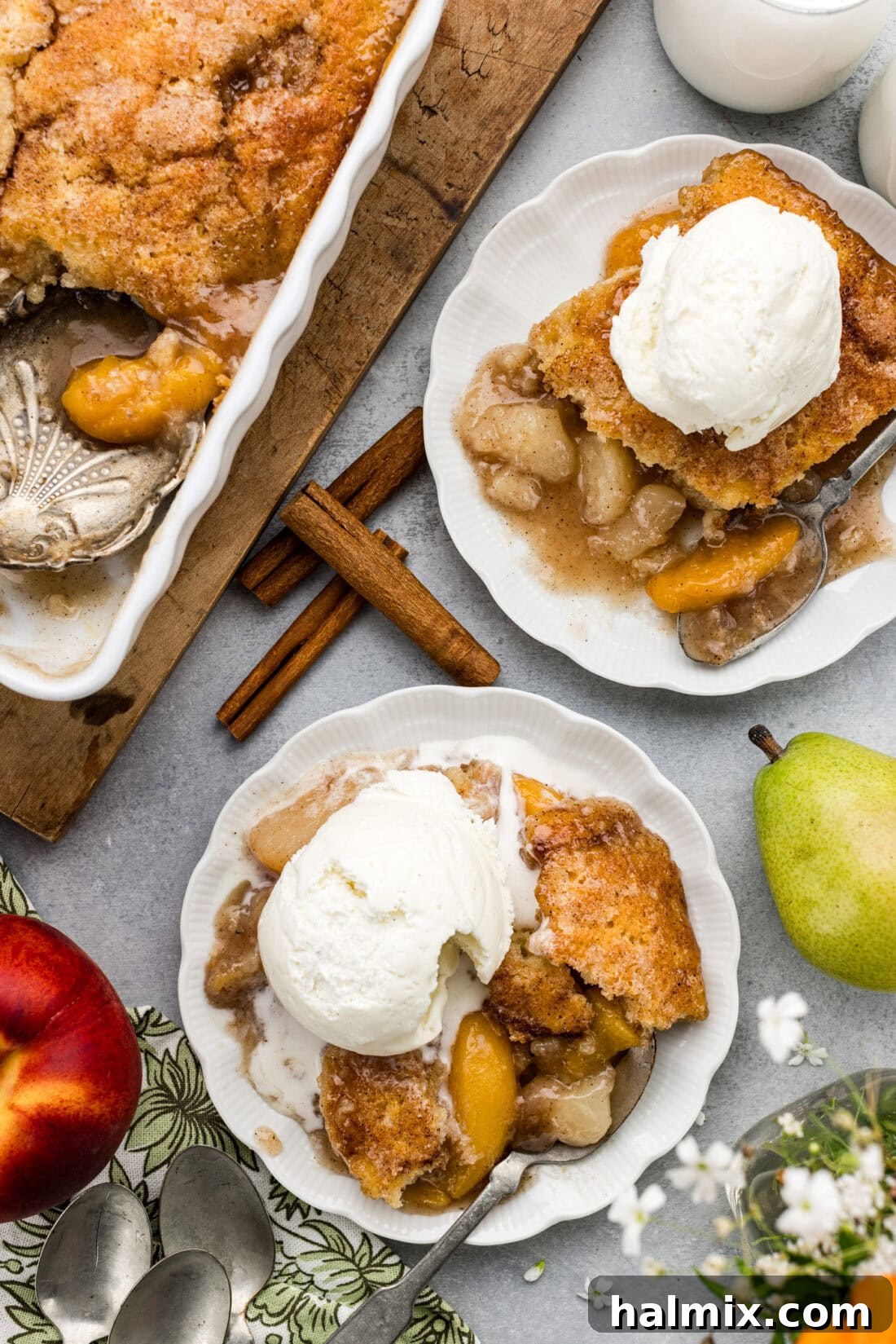 Two plates of Pear-Peach Cobbler topped with ice cream