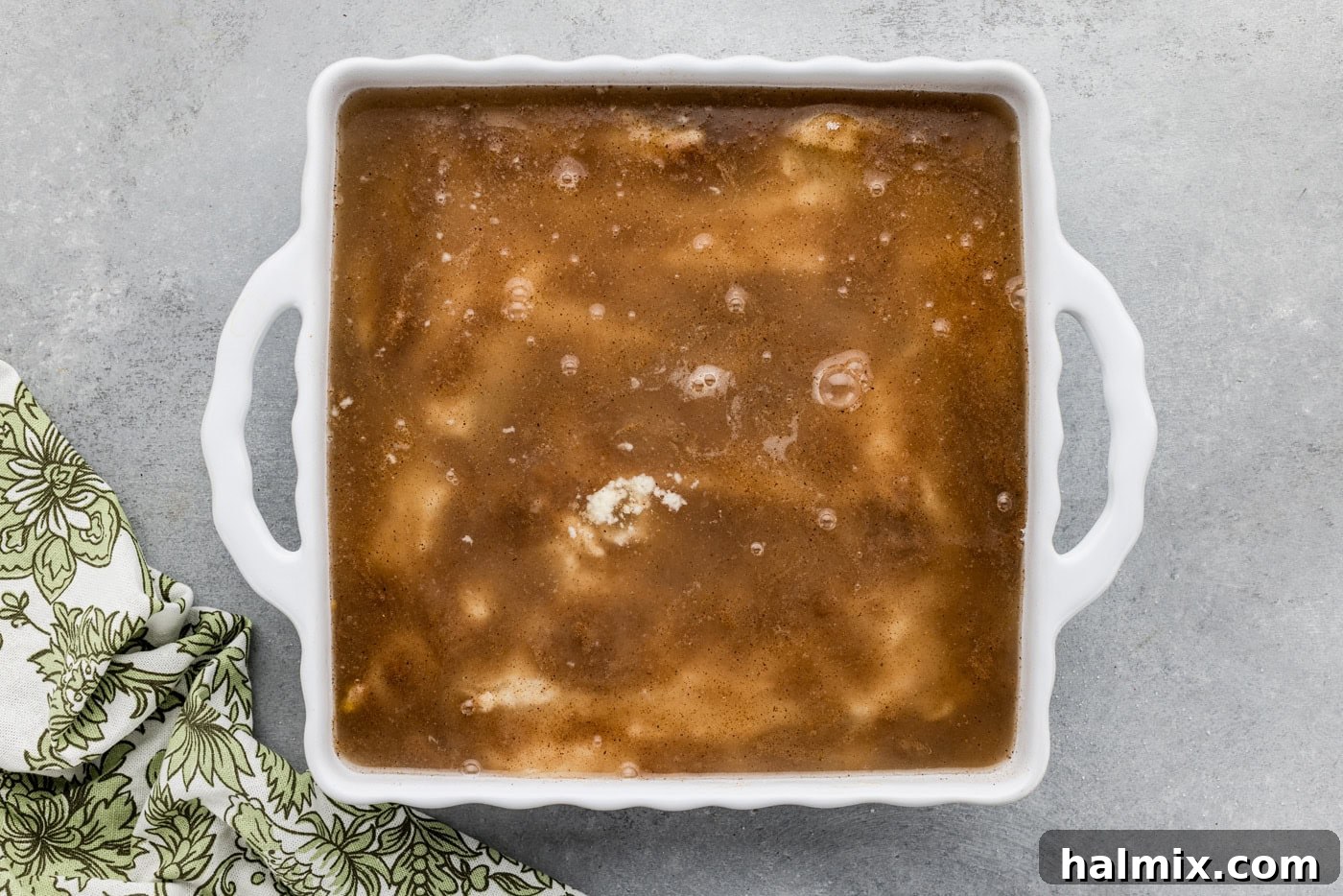 overhead of pear peach cobbler mixture in a baking dish