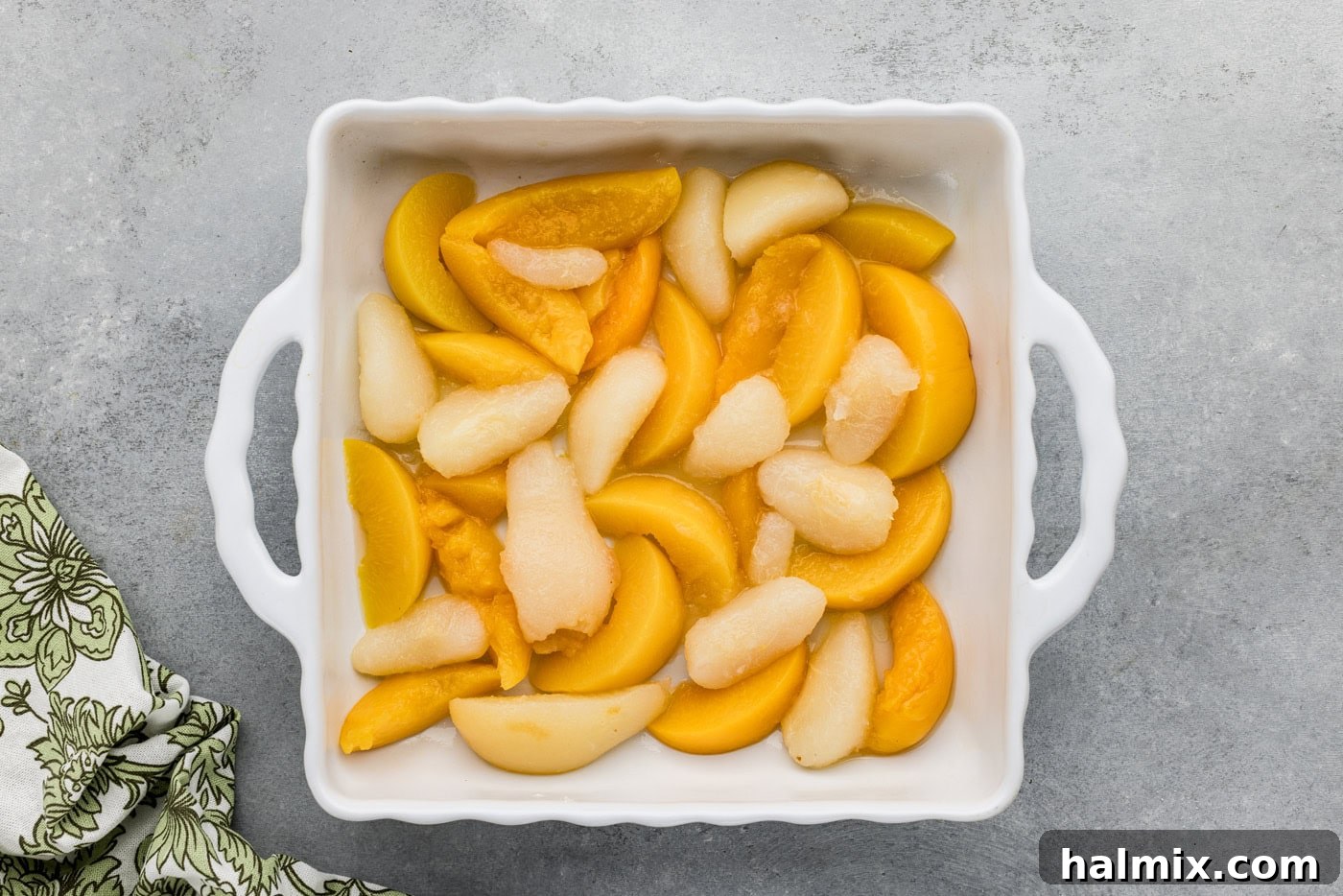 drained canned peaches and pears in a baking dish