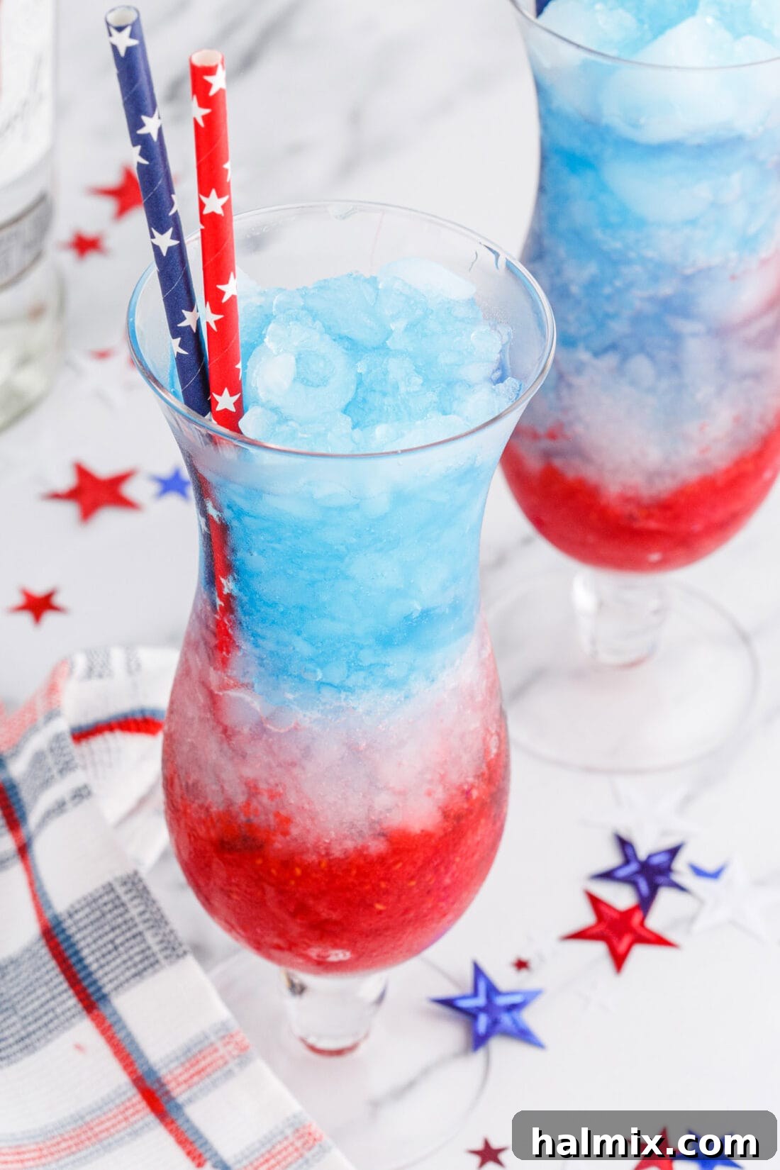 Freedom's Frosty Vodka Lemonade 11 Patriotic Vodka Lemonade Slushie garnished with fresh berries and a festive straw, ready for a celebration.