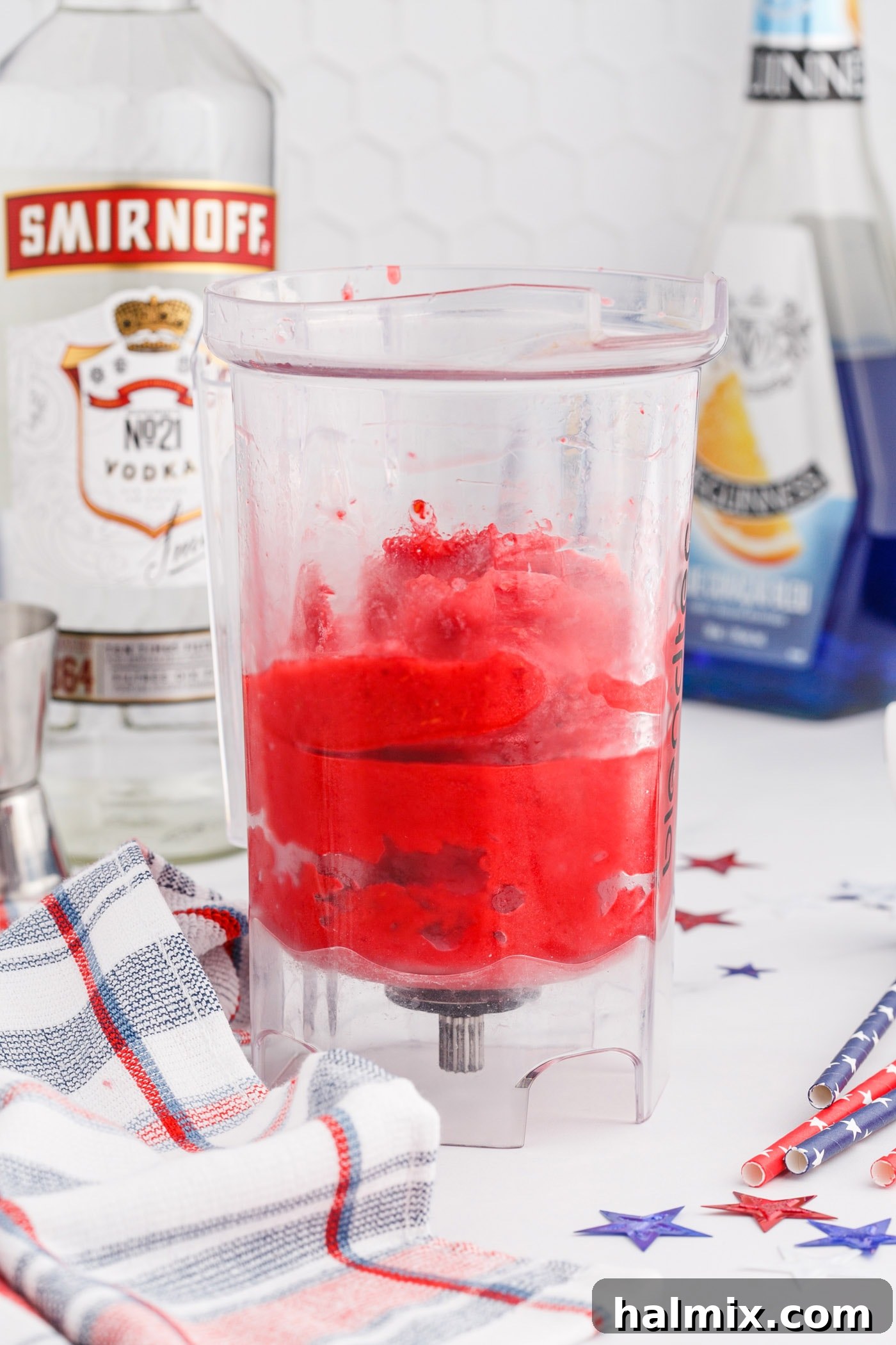 Blended vodka raspberry slush in a blender, showing the perfect thick consistency for layering.