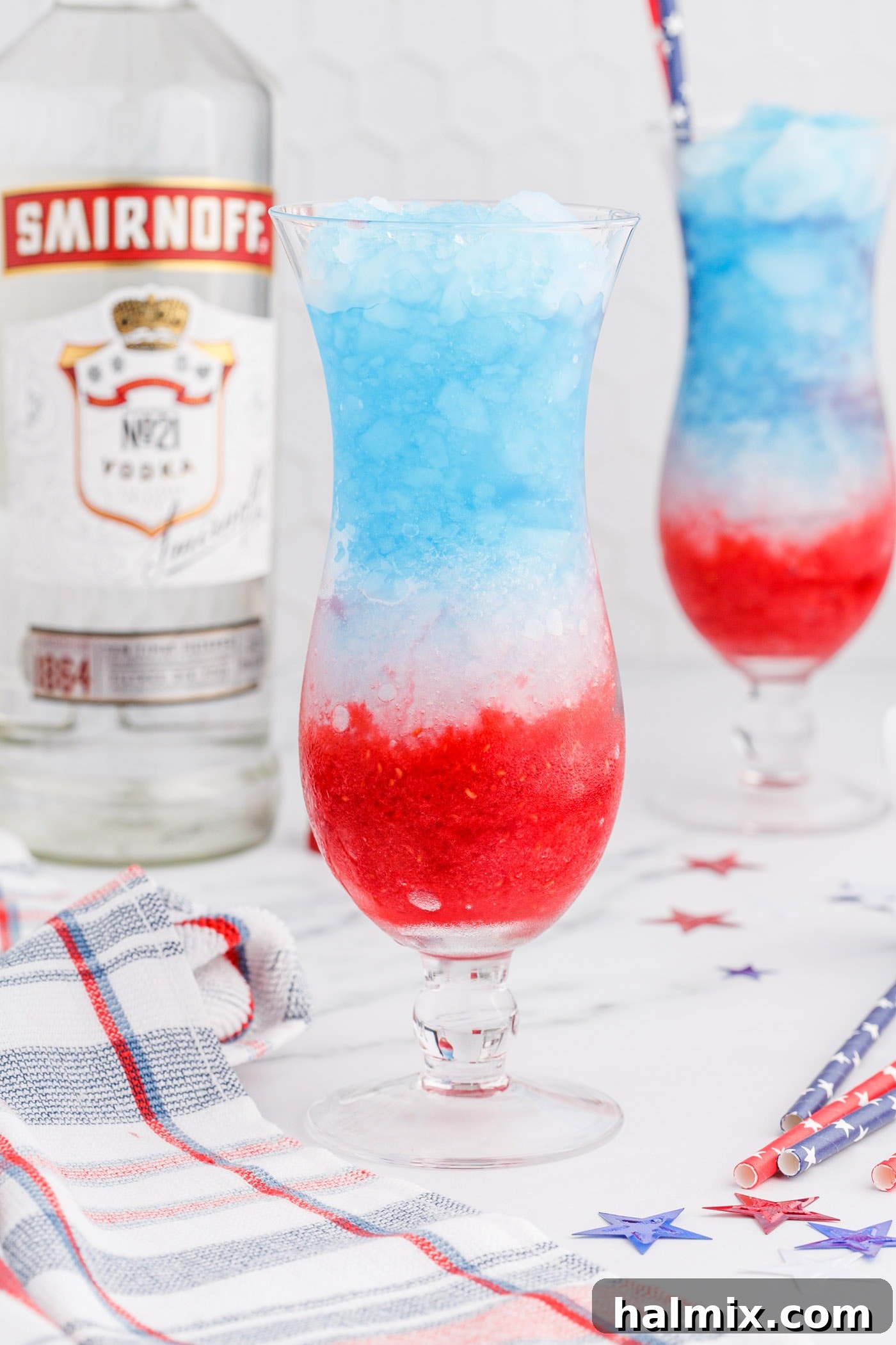 Layers of raspberry, lemonade, and blue curacao perfectly assembled in a drink glass, creating a patriotic masterpiece.