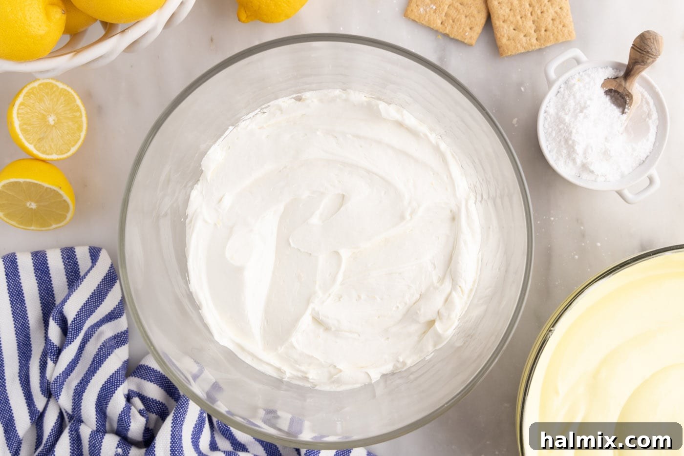 cream cheese mixture on top of graham cracker crumbs in trifle dish