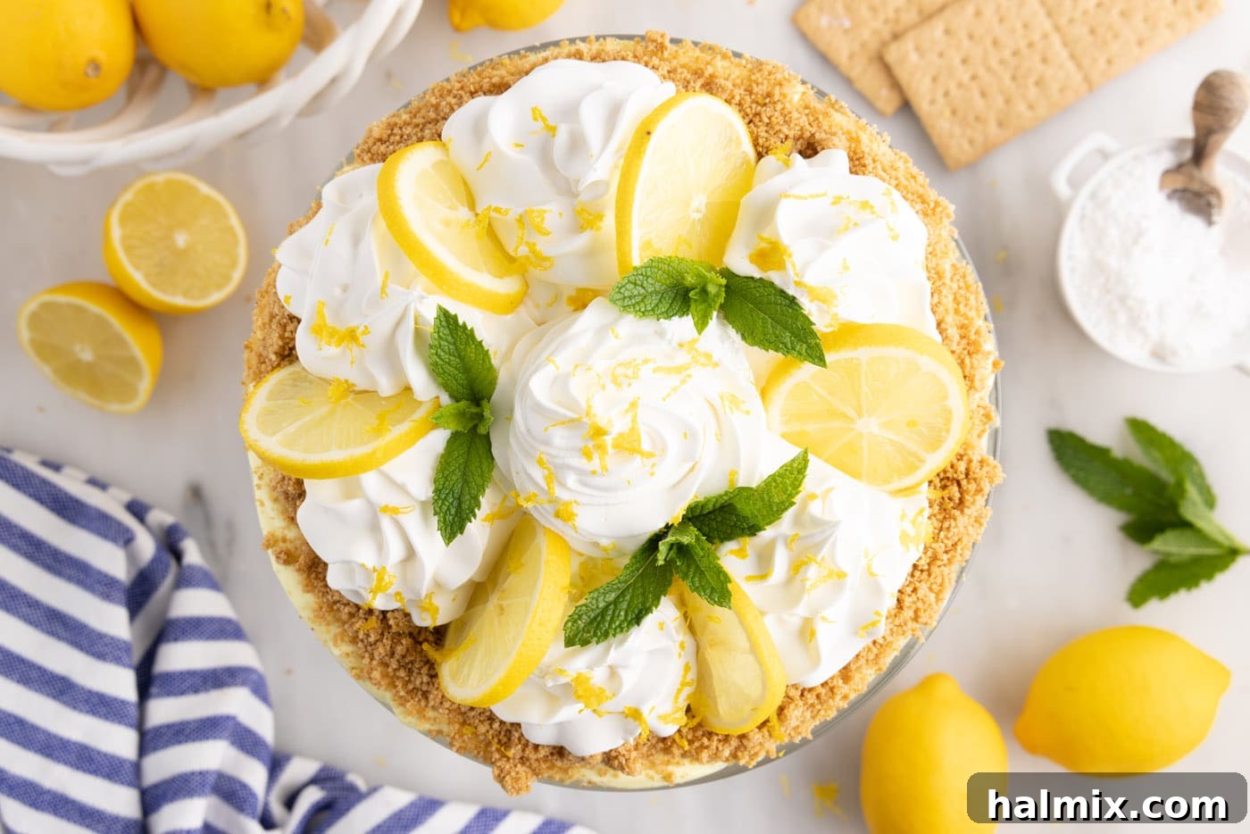 swirls of whipped cream, lemon slices, and fresh mint on top of lemon trifle