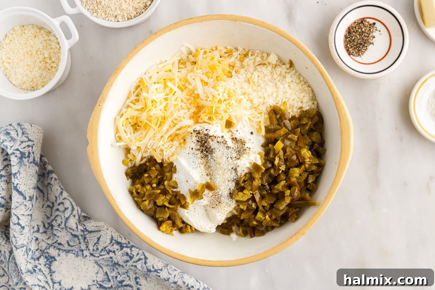 All ingredients for jalapeno popper dip assembled in a large mixing bowl before mixing