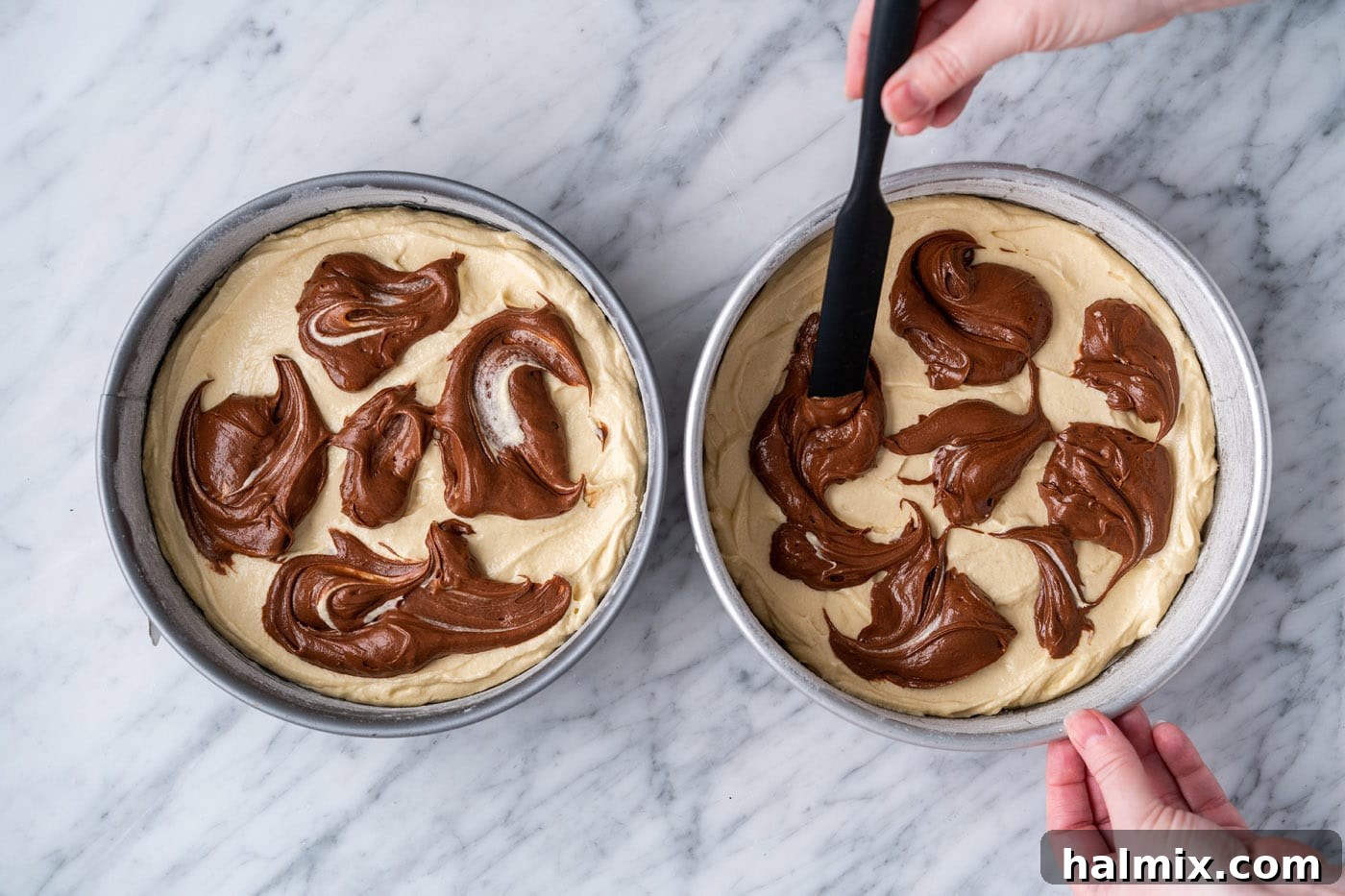 Swirled Delight 13 a spatula gently swirling chocolate batter into yellow batter in cake pans
