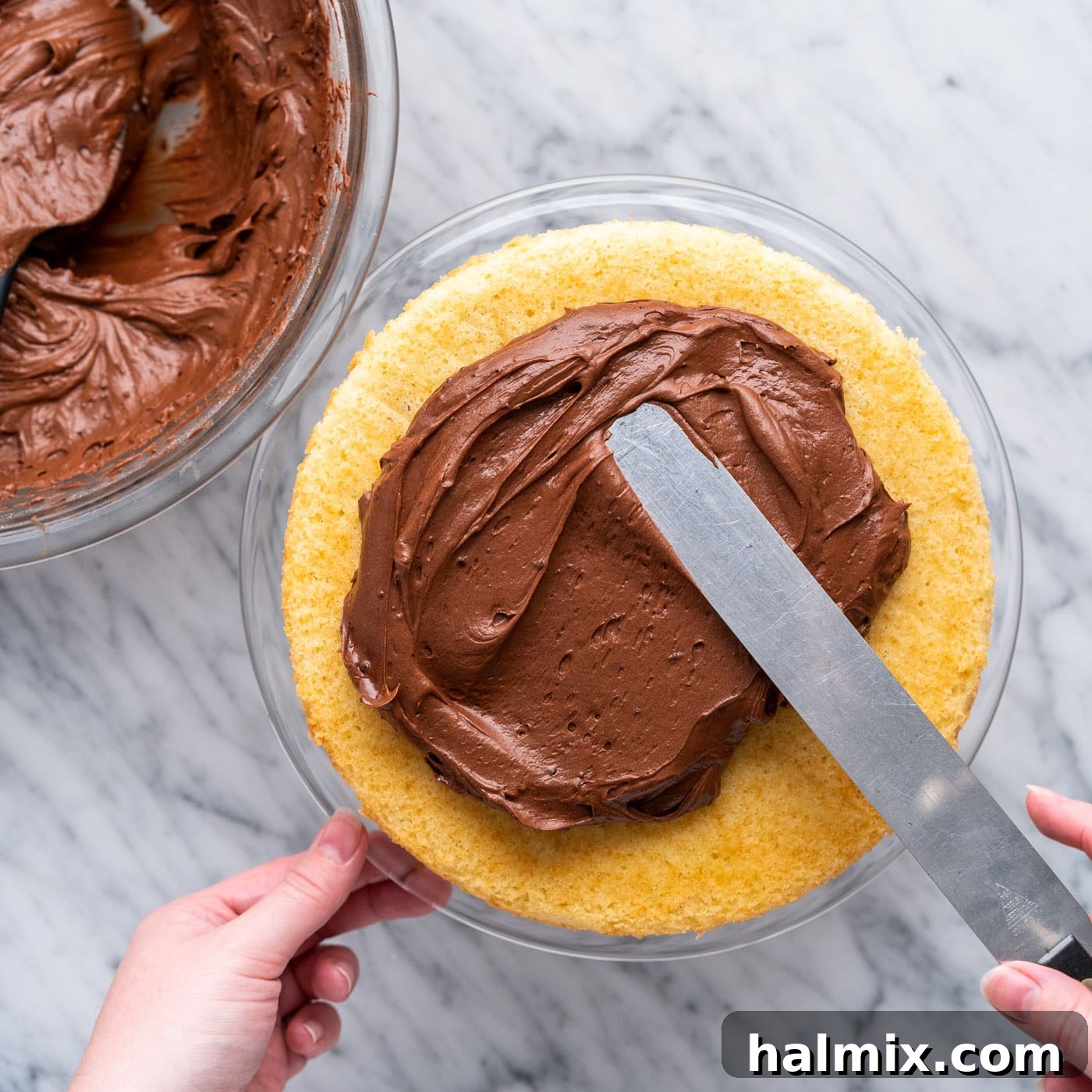 Swirled Delight 14 frosting the first layer of marble cake with chocolate fudge frosting