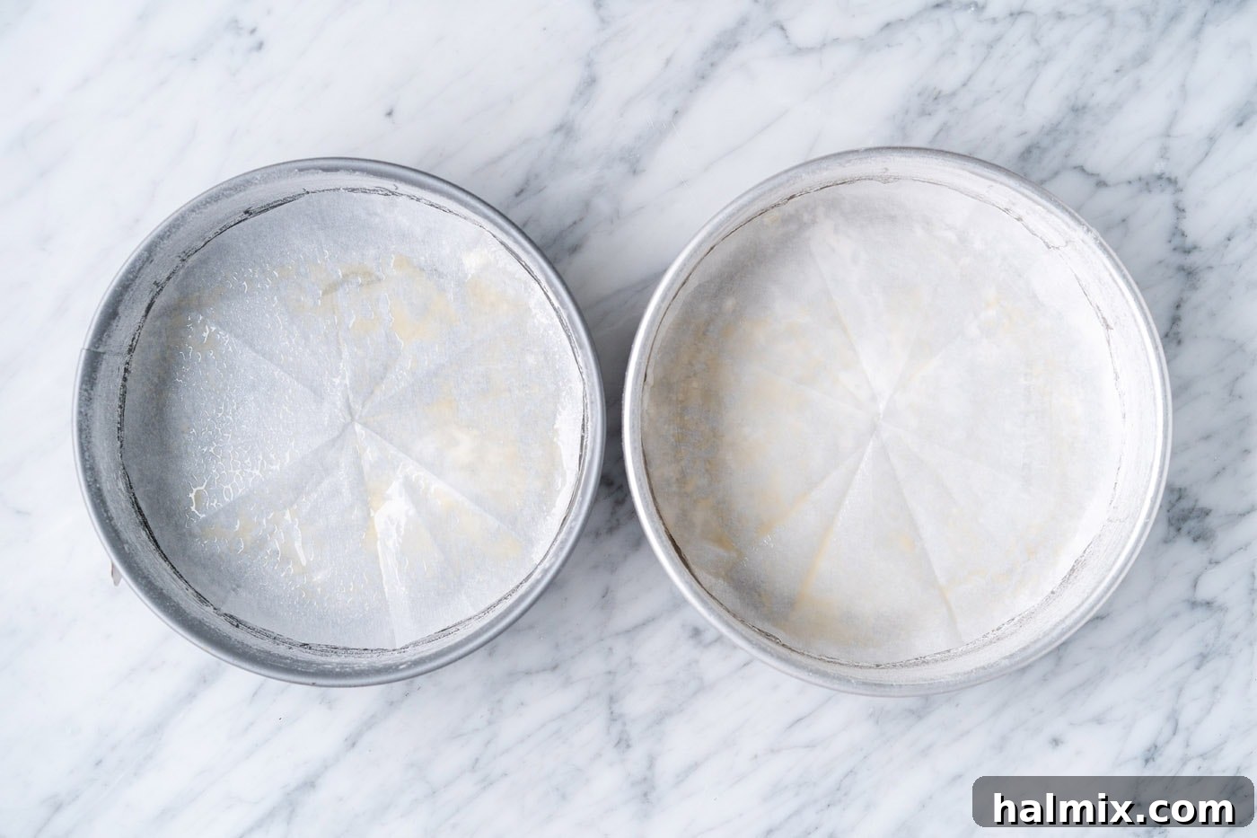 Swirled Delight 5 cake pans with parchment paper lining the bottom, ready for batter