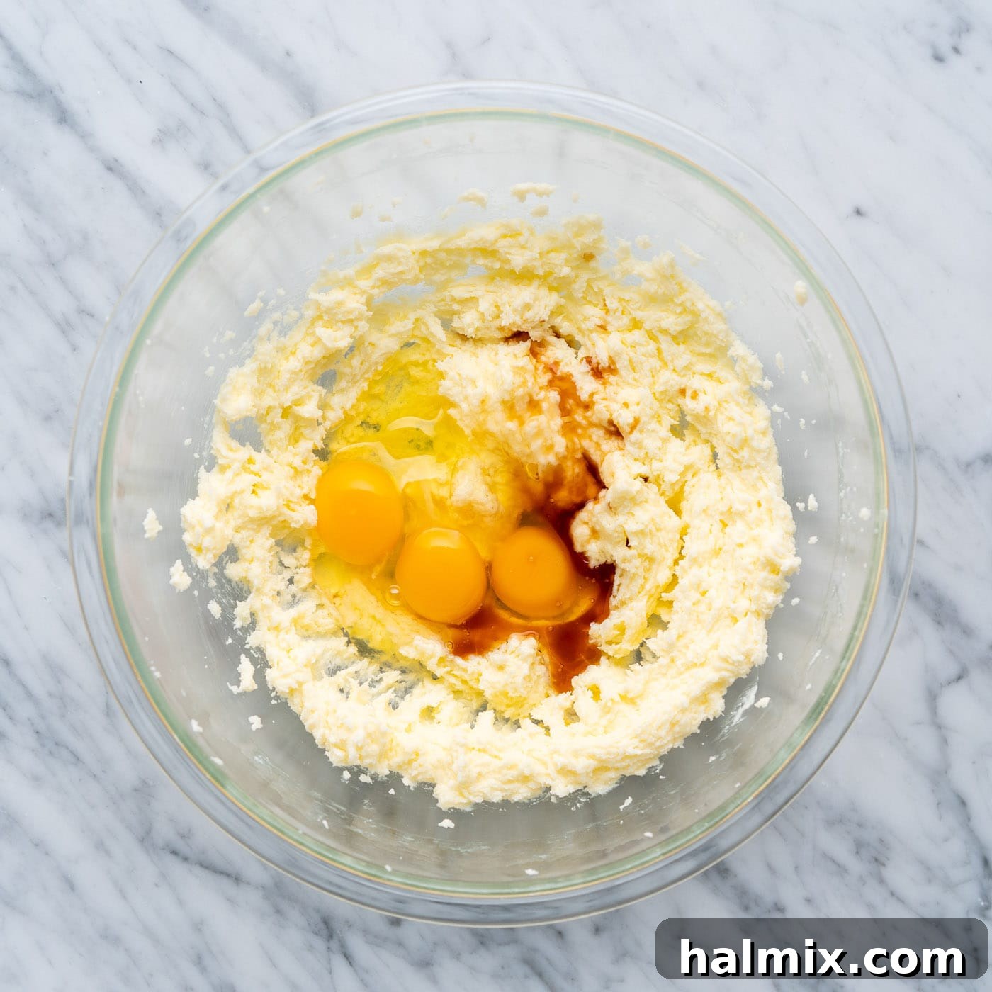 Swirled Delight 7 eggs and vanilla extract being added to the creamed butter and sugar mixture