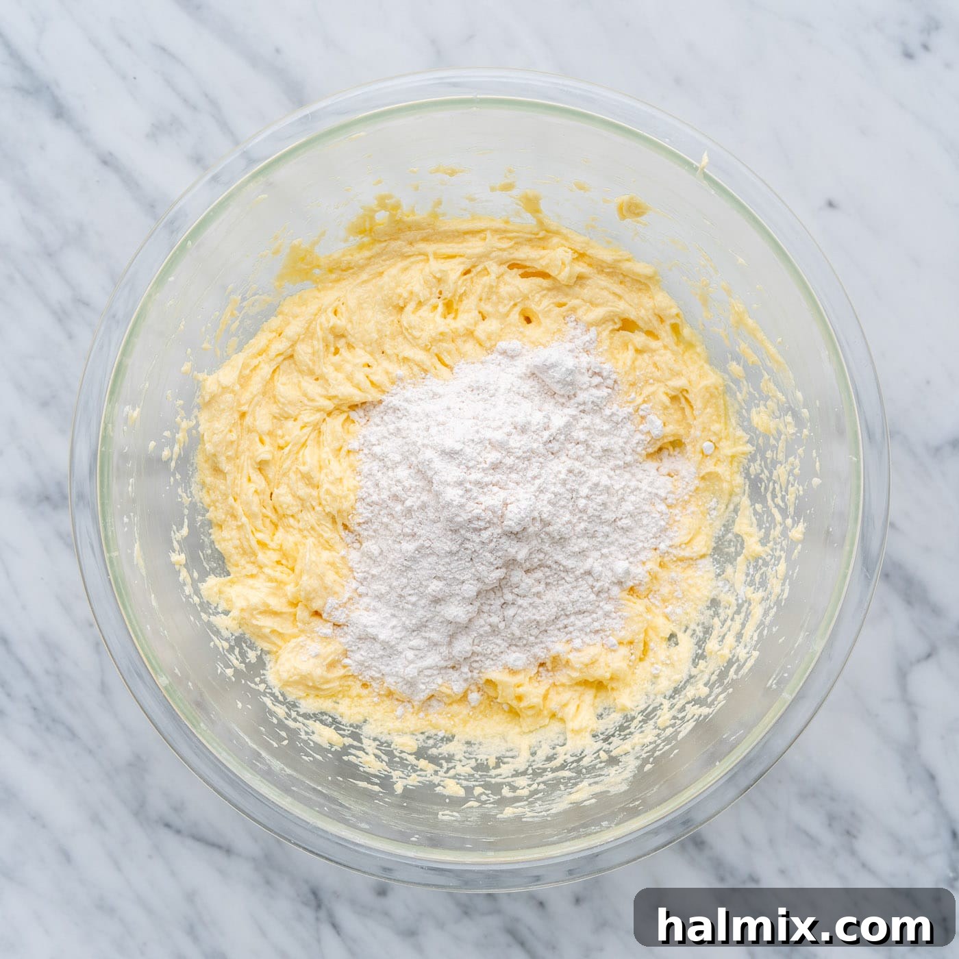 Swirled Delight 8 dry ingredients being added over wet ingredients in cake batter