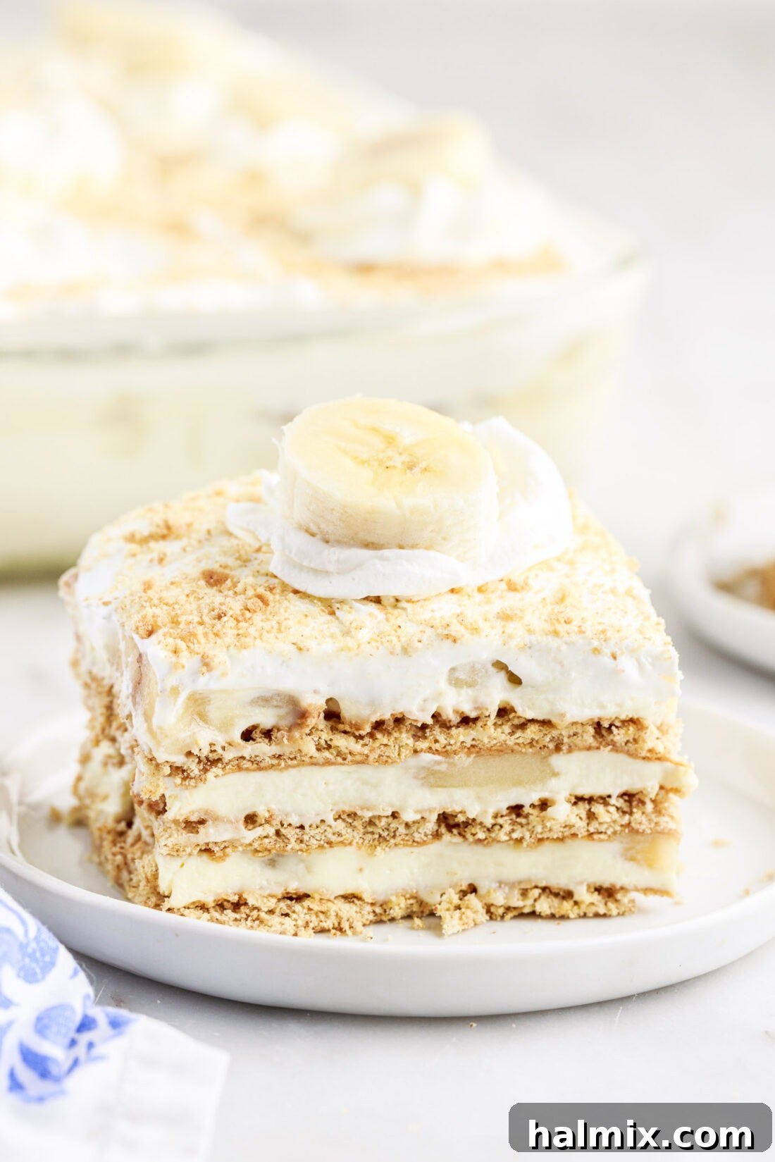A perfectly portioned slice of Banana Cream Pie Icebox Cake with a fork.