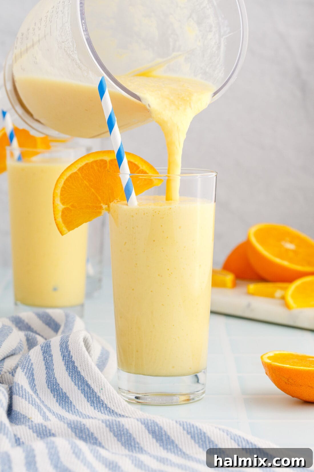 Golden Citrus Swirl 2 pouring an Orange Julius from a blender