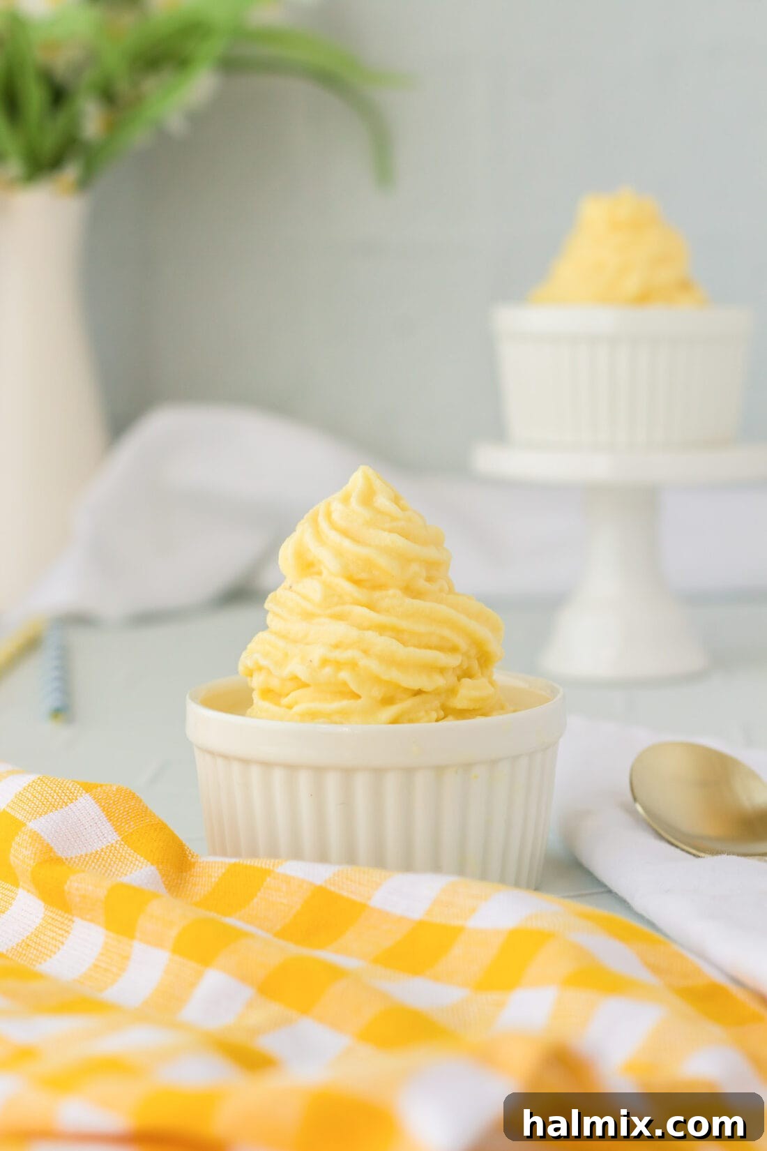 Tropical Pineapple Swirl 2 Two dishes of homemade Dole Whip, one in the foreground with a spoon