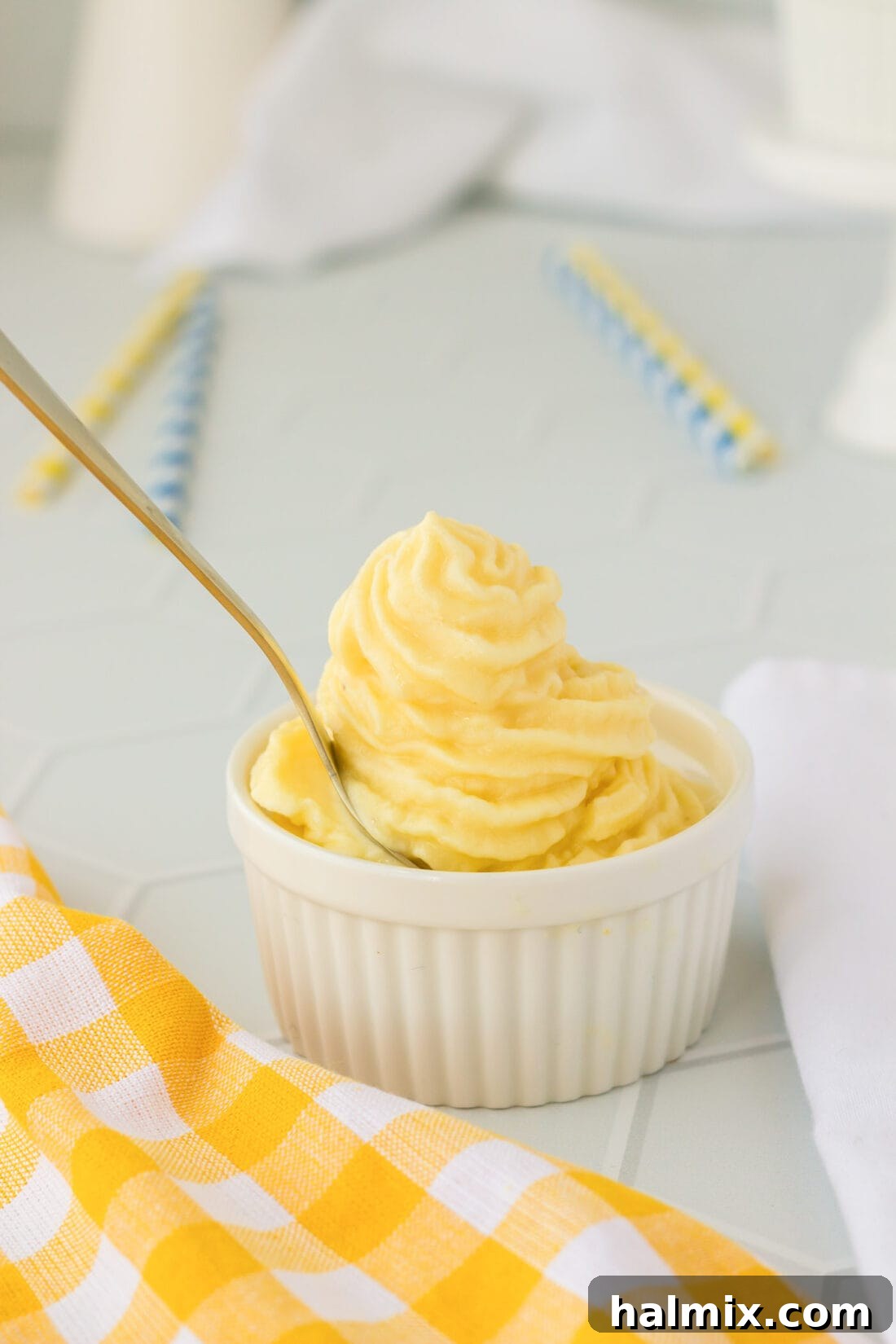Tropical Pineapple Swirl 3 A spoon scooping creamy homemade Dole Whip from a dish