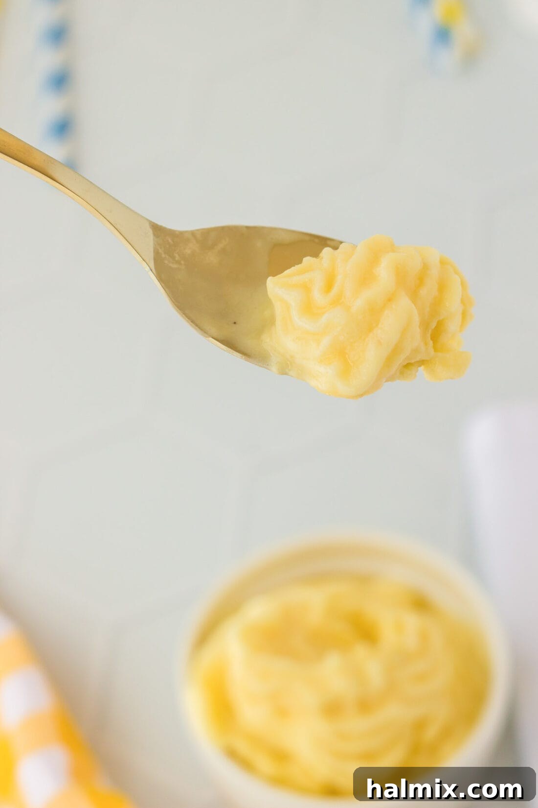 Tropical Pineapple Swirl 7 A close-up of a spoon scooping a perfectly swirled Dole Whip from a dish