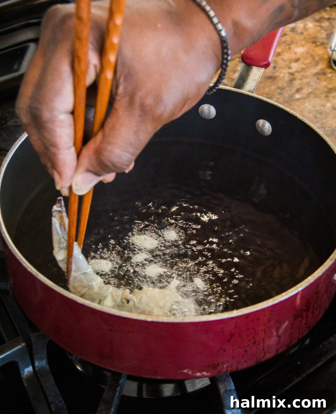 Crunchy Ocean Gems 8 placing battered shrimp in a hot oil